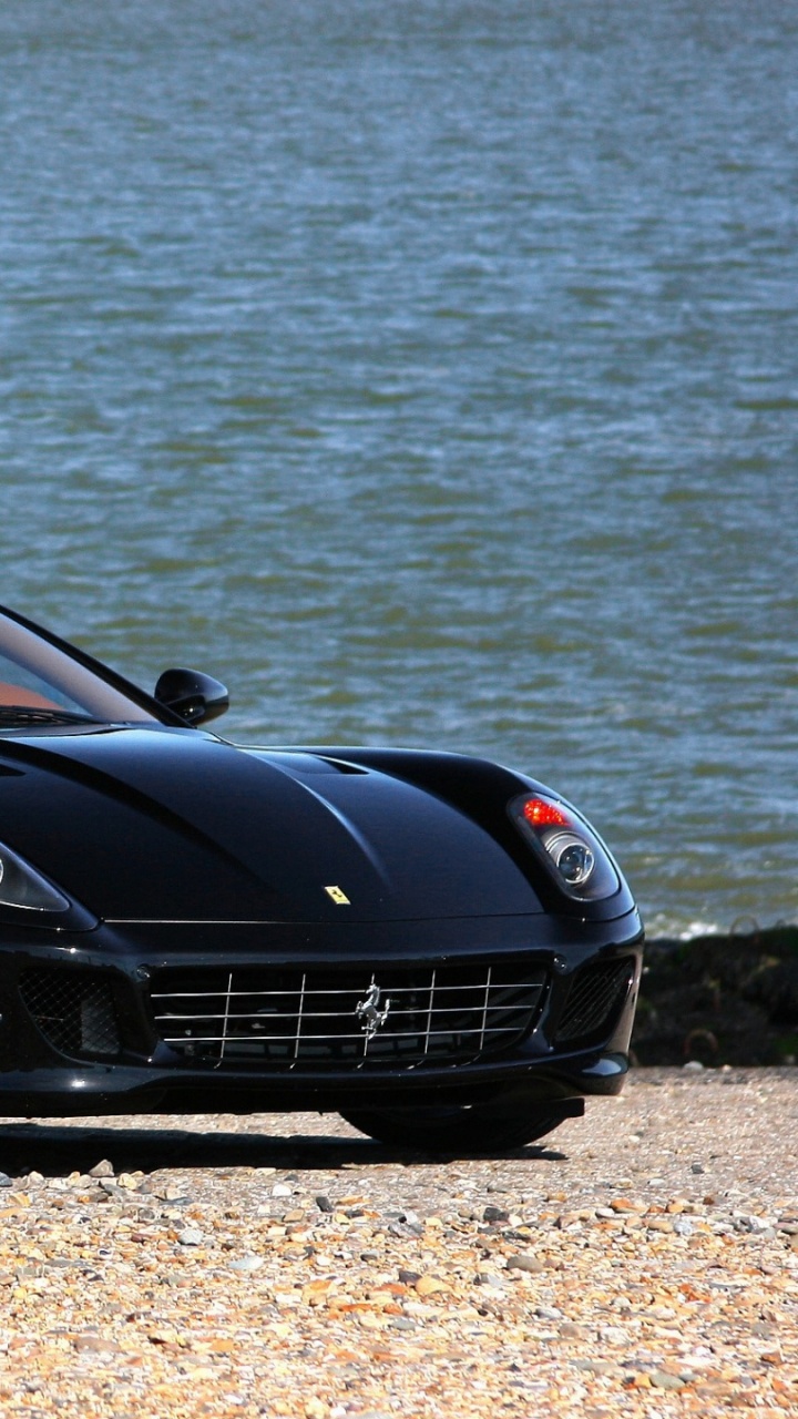 Black Porsche 911 Parked Near Body of Water During Daytime. Wallpaper in 720x1280 Resolution