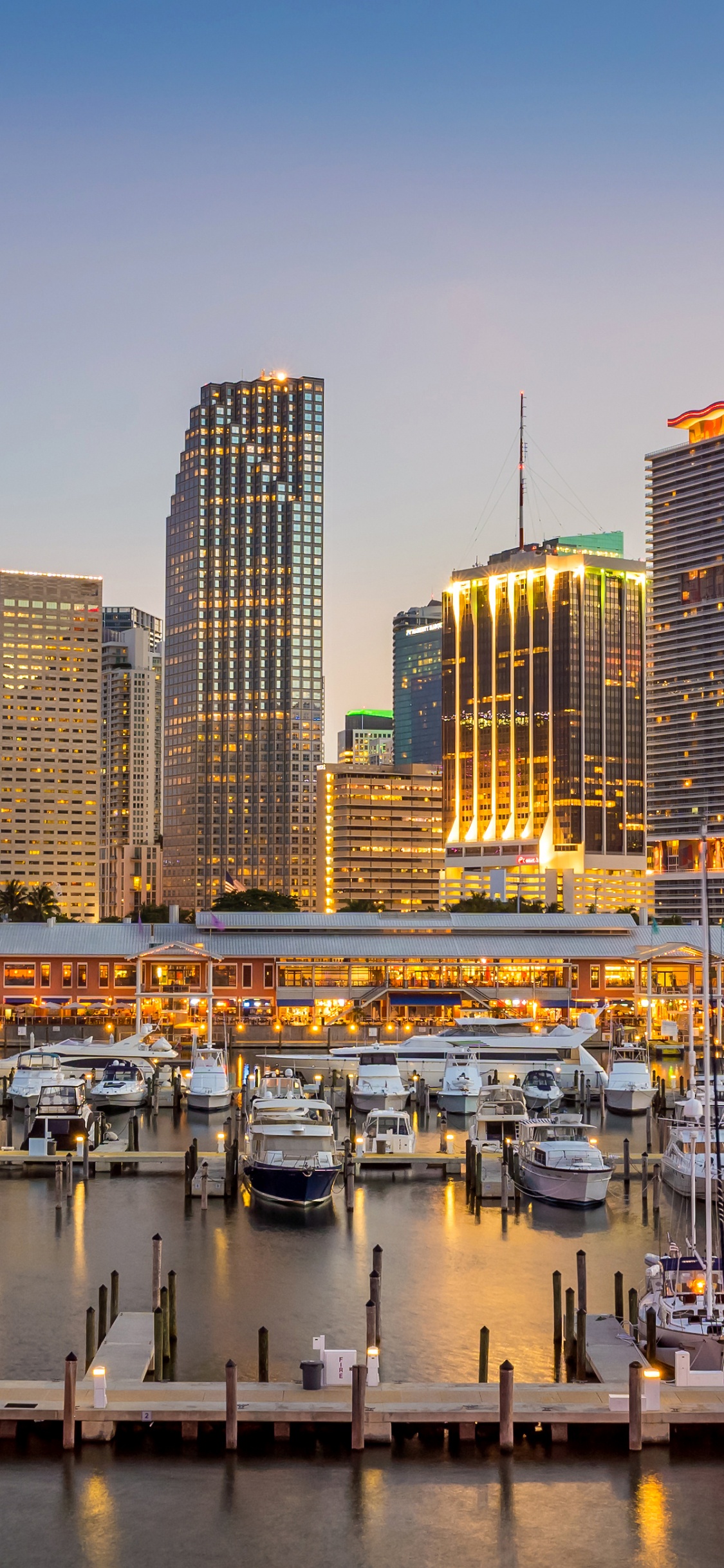 White and Black Boat on Body of Water Near City Buildings During Daytime. Wallpaper in 1125x2436 Resolution