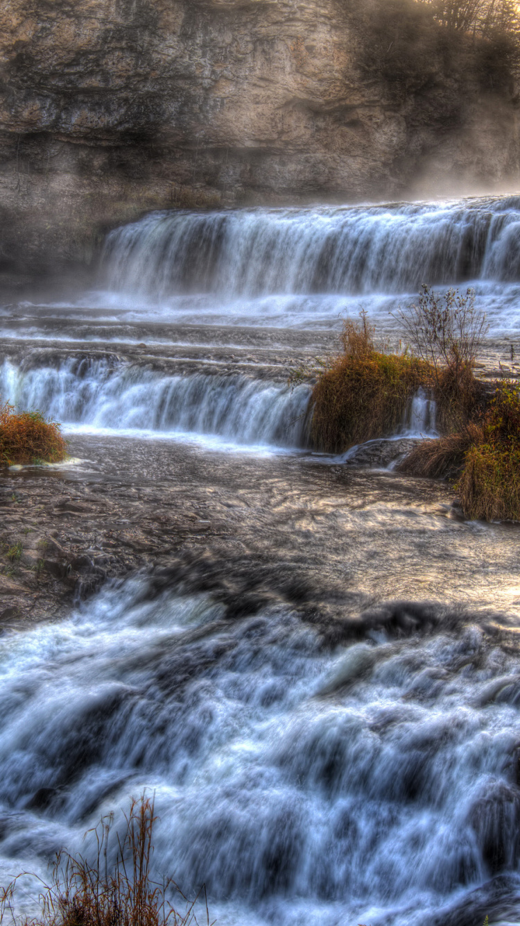 Water Falls in Brown Field. Wallpaper in 750x1334 Resolution