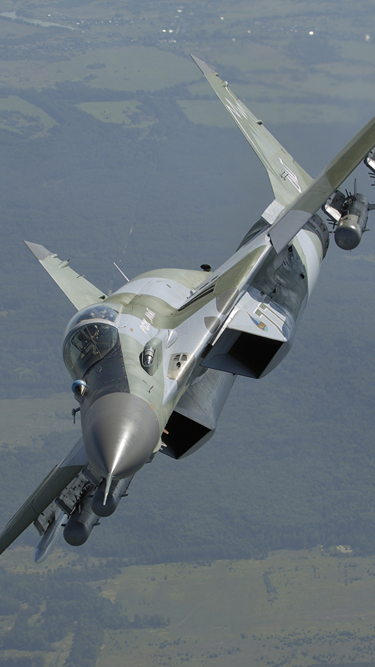 Gray Fighter Jet Flying Over The Sky During Daytime. Wallpaper in 750x1334 Resolution