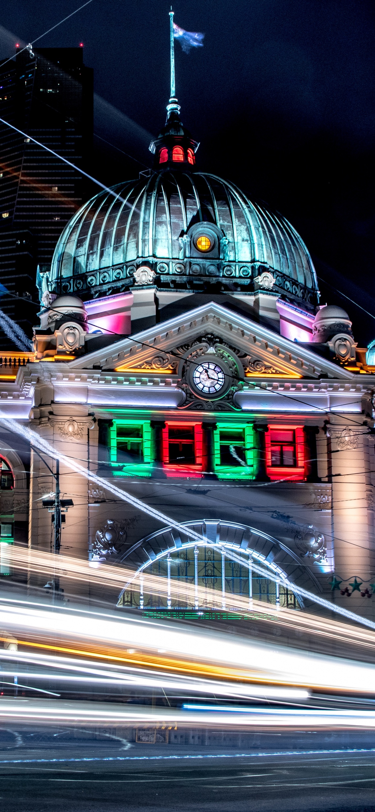 Time Lapse Photography of Cars on Road Near Green and Brown Dome Building During Night Time. Wallpaper in 1242x2688 Resolution