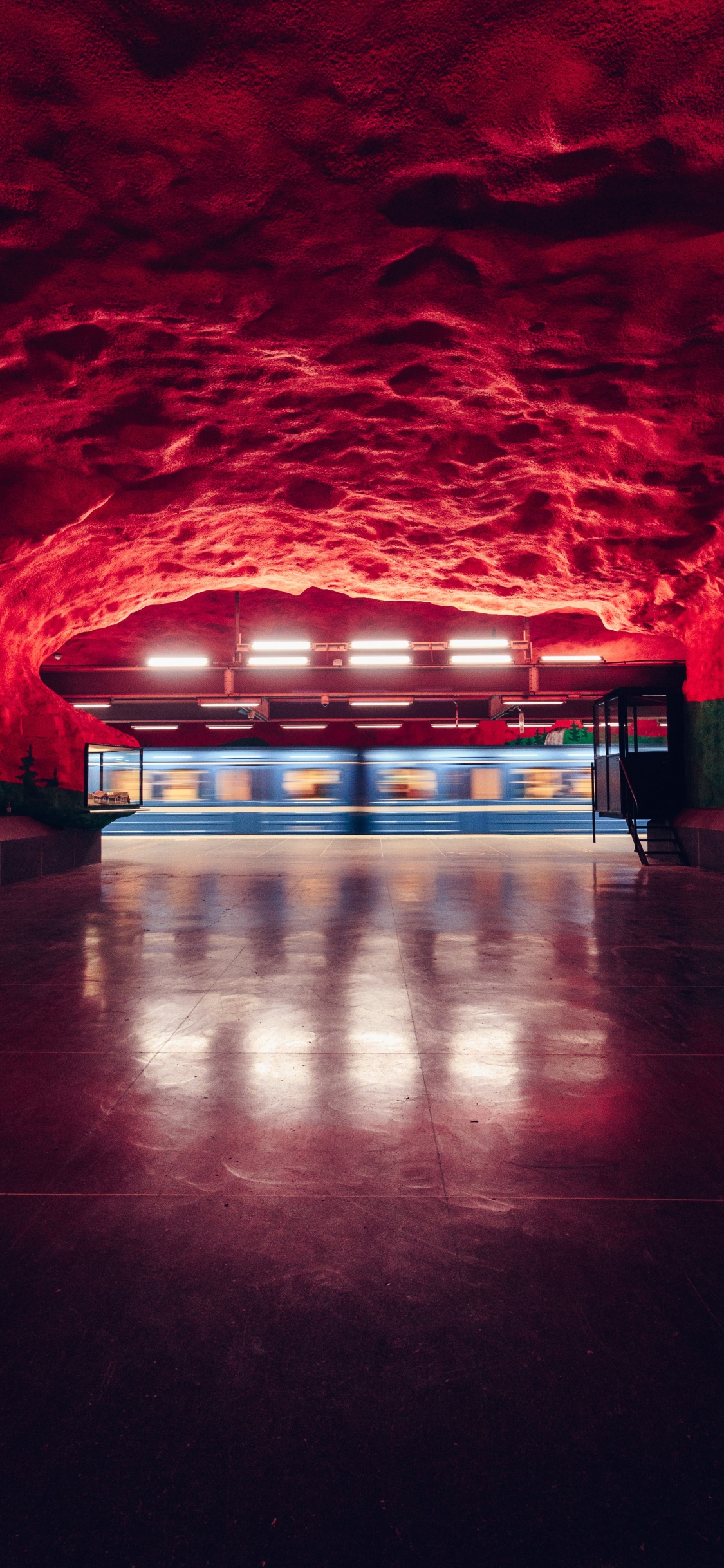 Brown Concrete Floor With Red and Blue Lights. Wallpaper in 1125x2436 Resolution