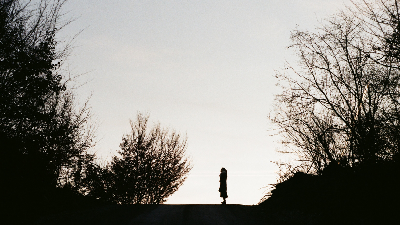 Silhouette of Man Standing on Rock. Wallpaper in 1366x768 Resolution