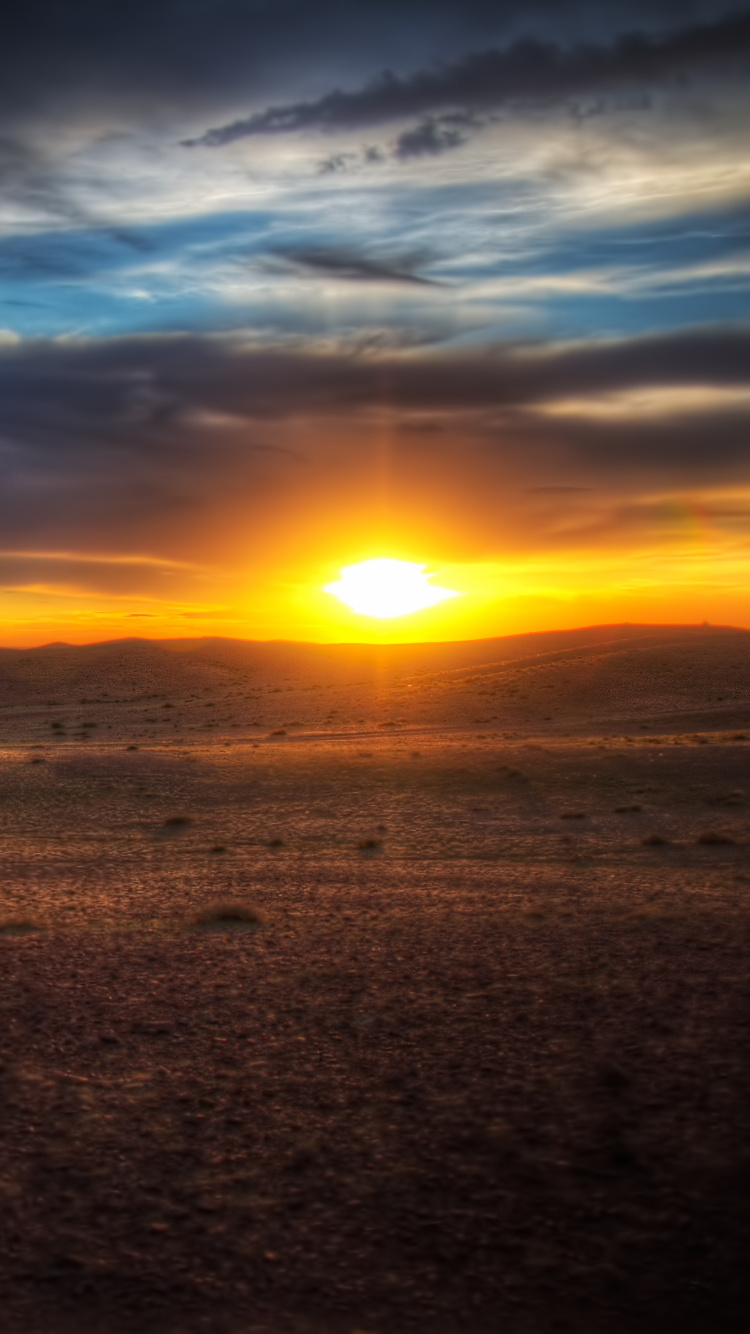 Brown Sand Under Blue Sky During Sunset. Wallpaper in 750x1334 Resolution