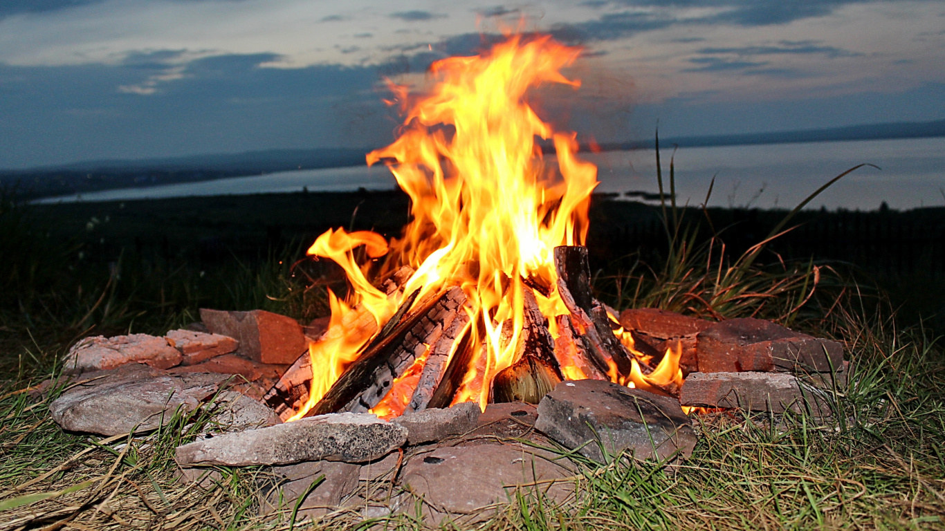 Burning Wood on Gray Rock. Wallpaper in 1366x768 Resolution