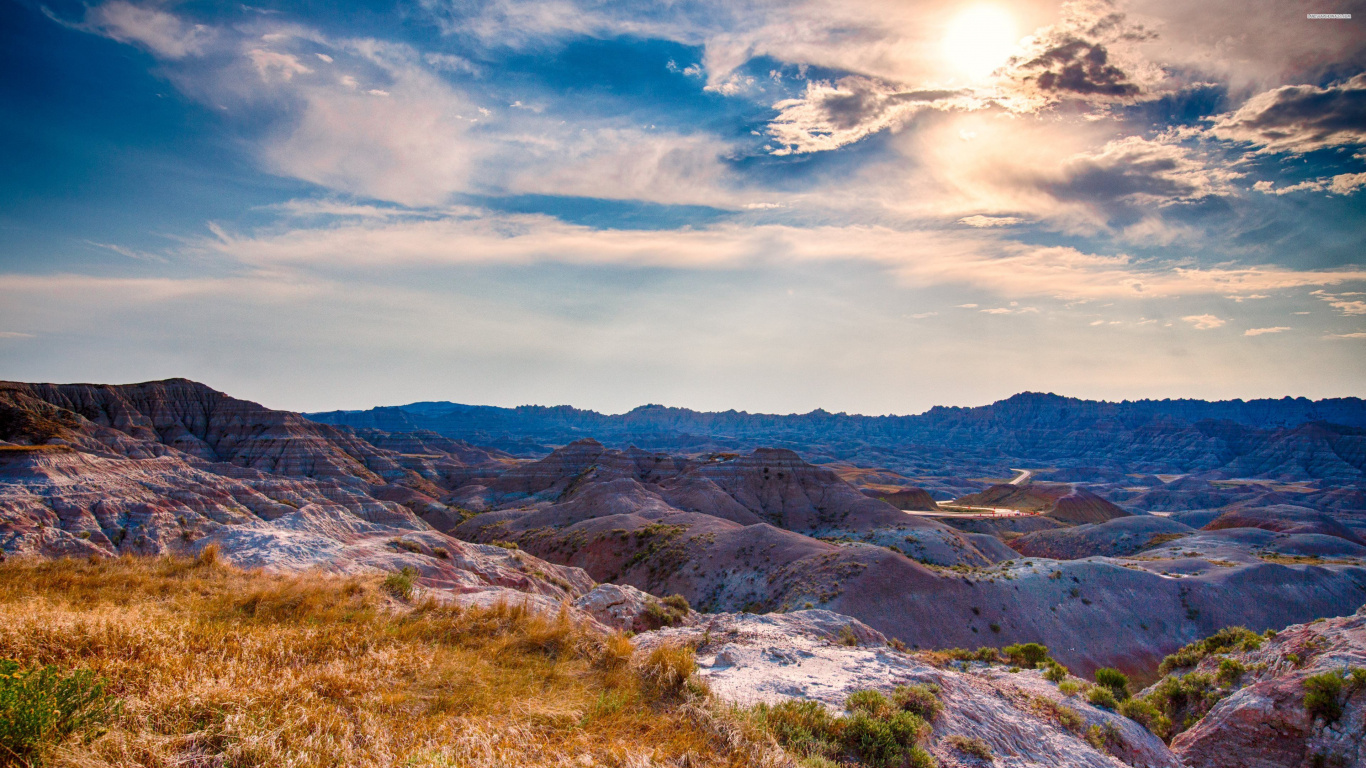 Brown and Green Mountains Under White Clouds and Blue Sky During Daytime. Wallpaper in 1366x768 Resolution
