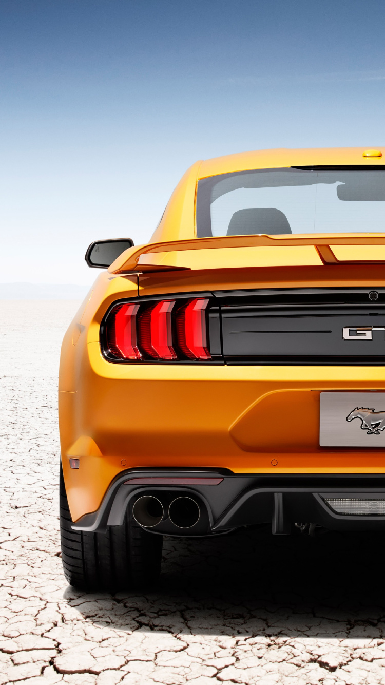 Orange Chevrolet Camaro on Road During Daytime. Wallpaper in 750x1334 Resolution