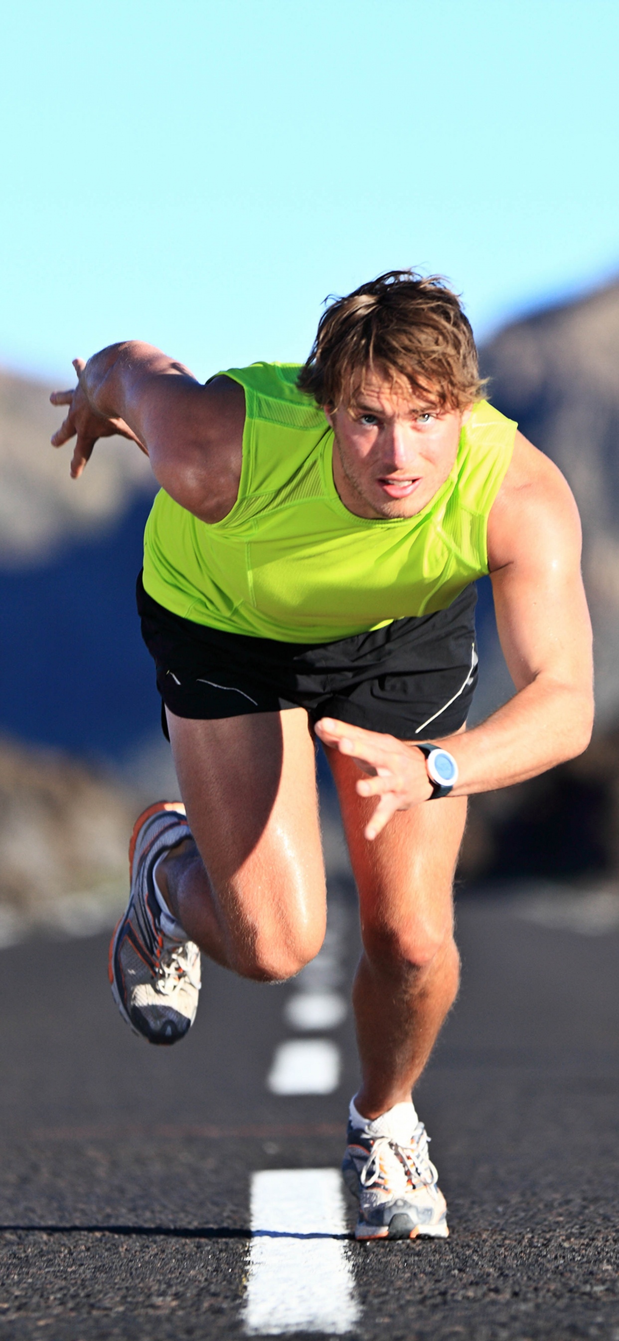 Man in Green Shirt Running on Road During Daytime. Wallpaper in 1242x2688 Resolution
