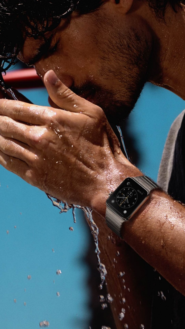 Man in Gray Tank Top Wearing Black Watch. Wallpaper in 720x1280 Resolution