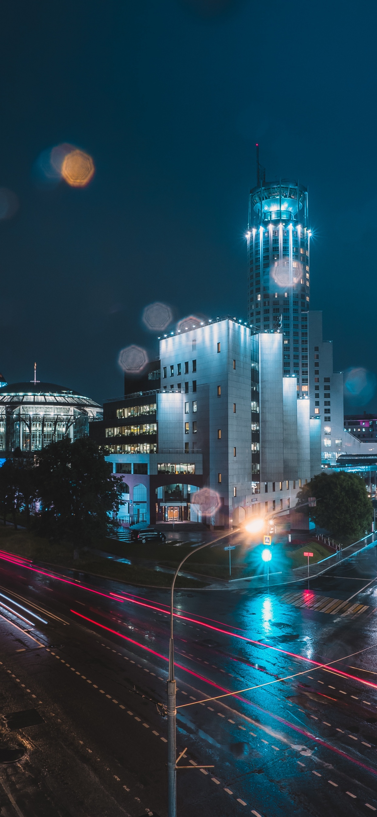 Cars on Road Near City Buildings During Night Time. Wallpaper in 1242x2688 Resolution
