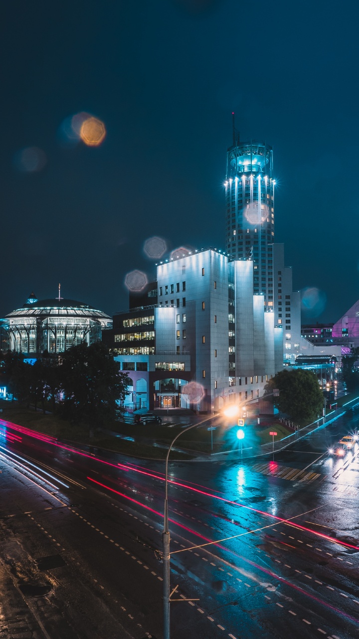Cars on Road Near City Buildings During Night Time. Wallpaper in 720x1280 Resolution