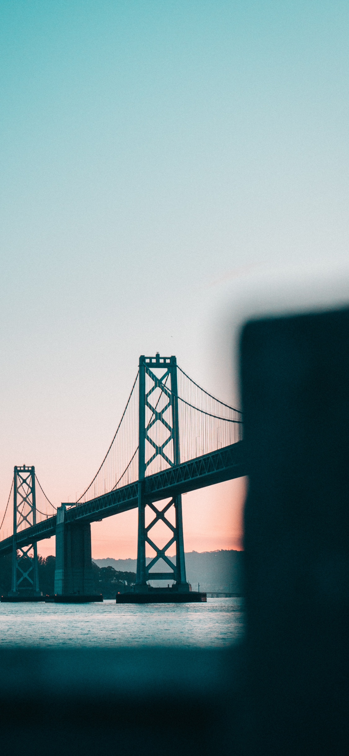 Bridge Over Body of Water. Wallpaper in 1125x2436 Resolution