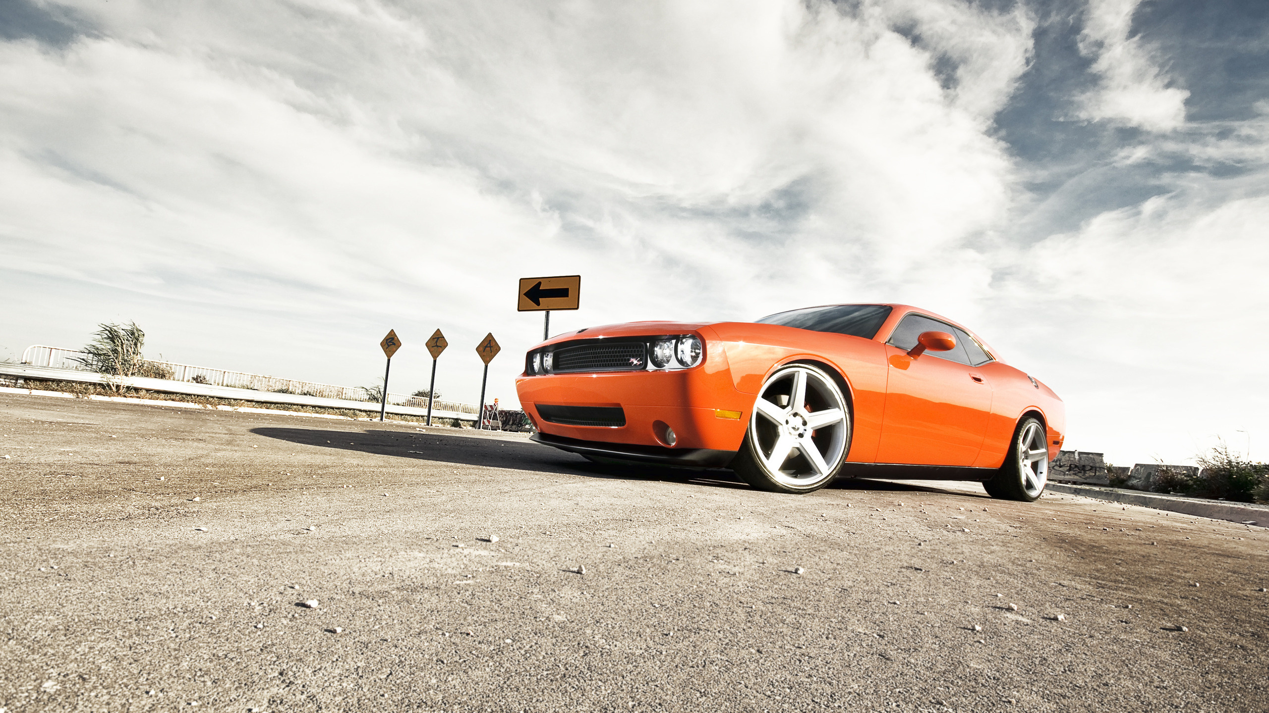 Orange Porsche 911 on Gray Asphalt Road Under White Clouds During Daytime. Wallpaper in 2560x1440 Resolution