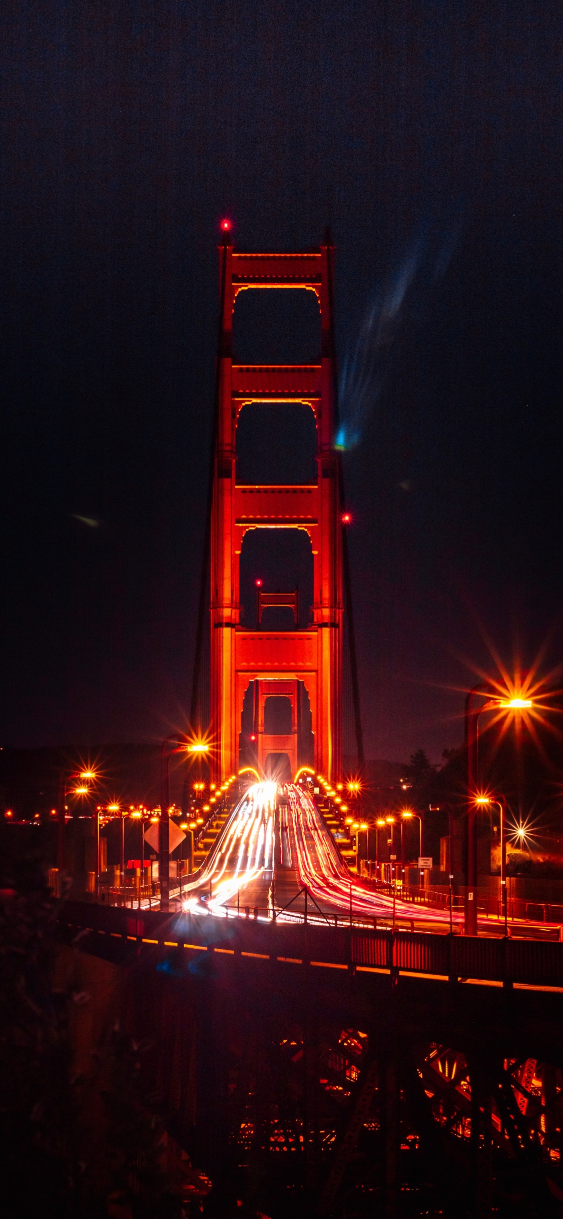 Red Tower With Lights During Night Time. Wallpaper in 1125x2436 Resolution