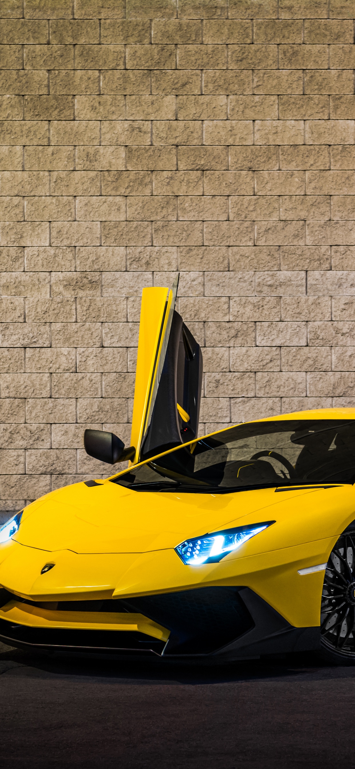 Ferrari 458 Italia Amarillo Estacionado Junto a la Pared de Ladrillo Marrón. Wallpaper in 1242x2688 Resolution