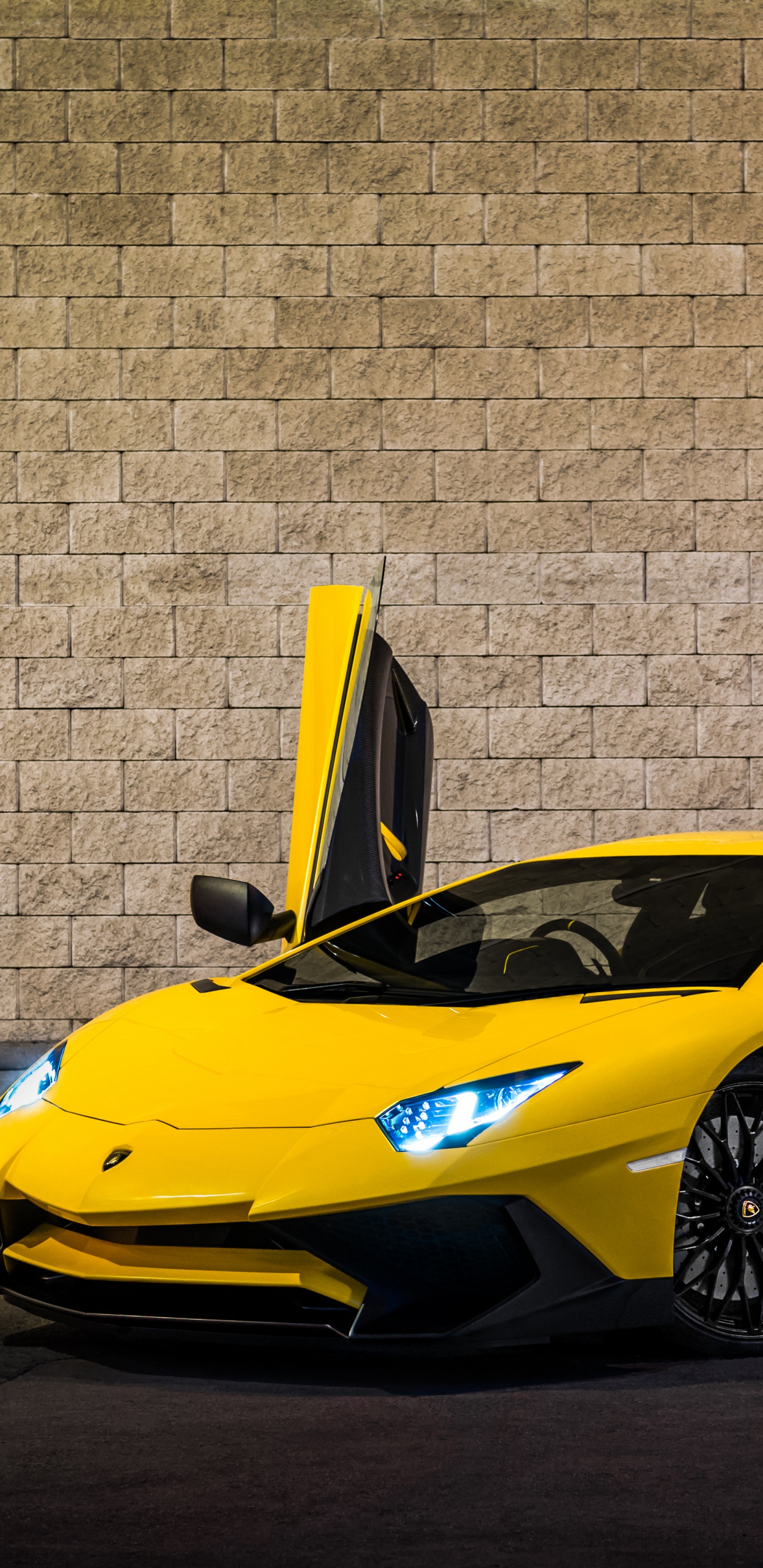 Yellow Ferrari 458 Italia Parked Beside Brown Brick Wall. Wallpaper in 1440x2960 Resolution