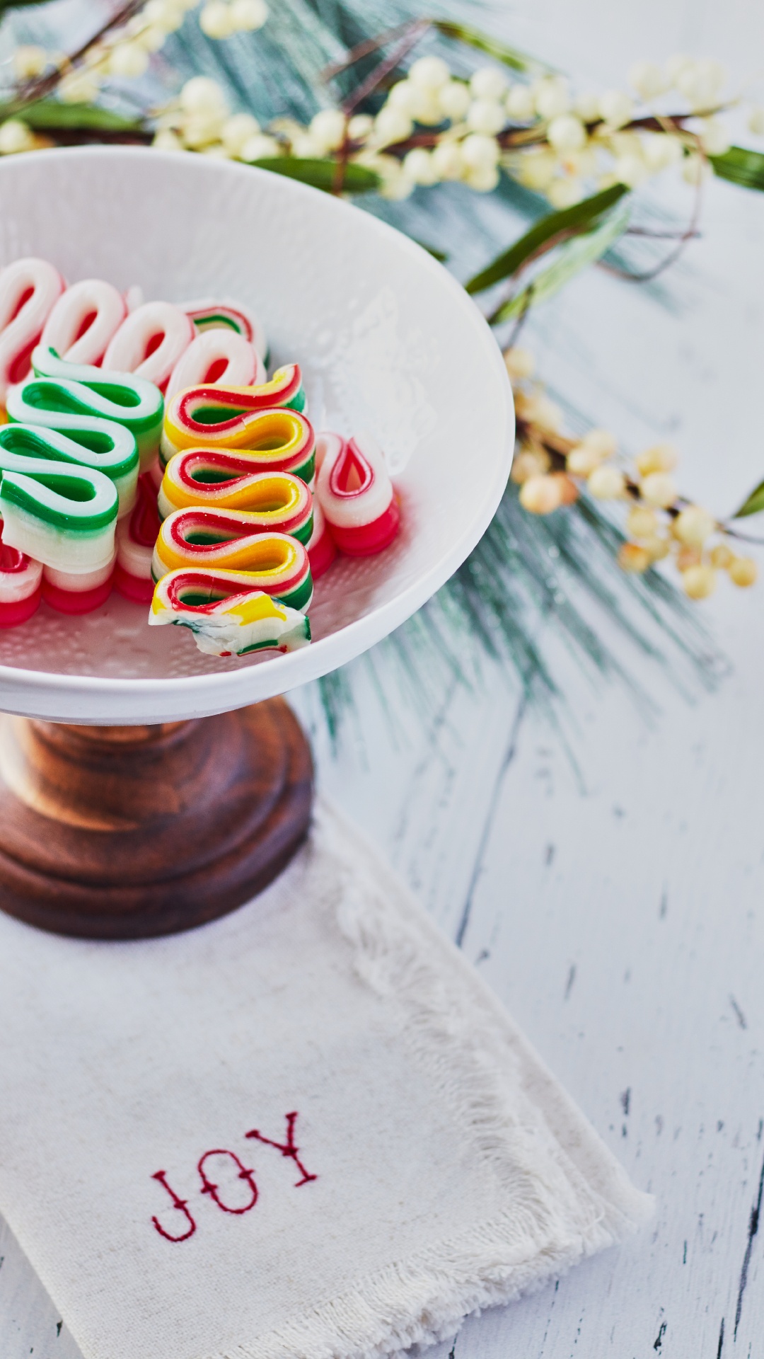 White Ceramic Round Plate With Multi Colored Candies. Wallpaper in 1080x1920 Resolution