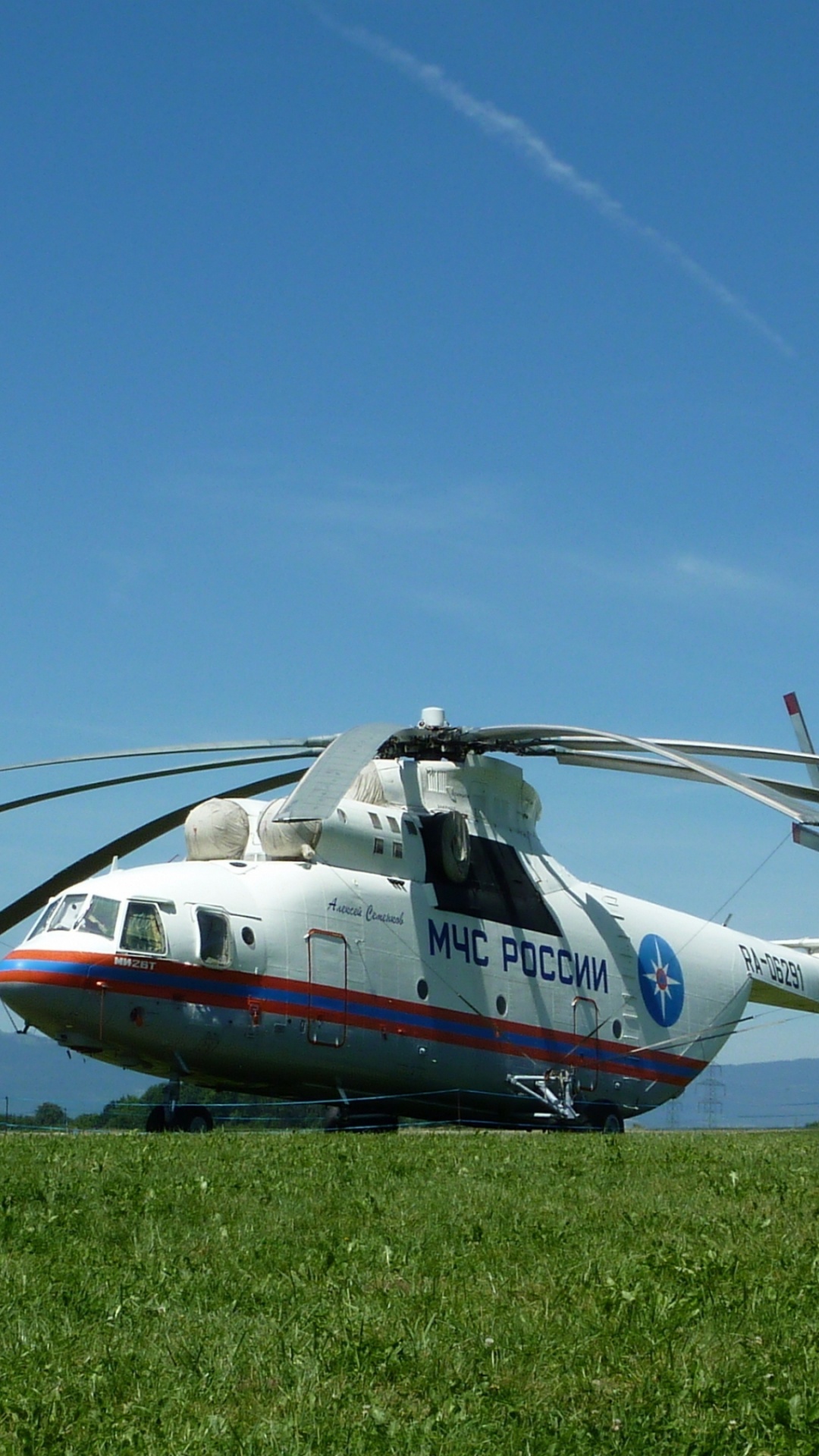 White and Red Helicopter on Green Grass Field Under Blue Sky During Daytime. Wallpaper in 1080x1920 Resolution