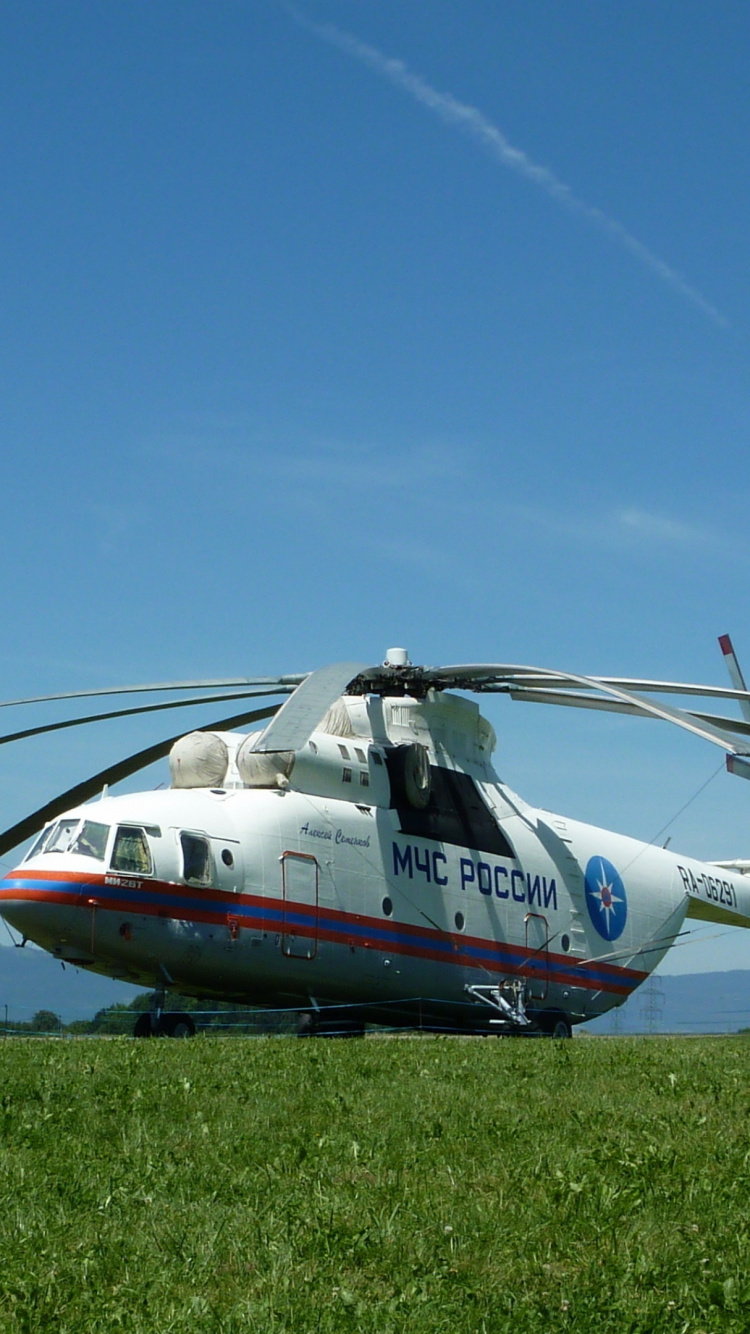 White and Red Helicopter on Green Grass Field Under Blue Sky During Daytime. Wallpaper in 750x1334 Resolution