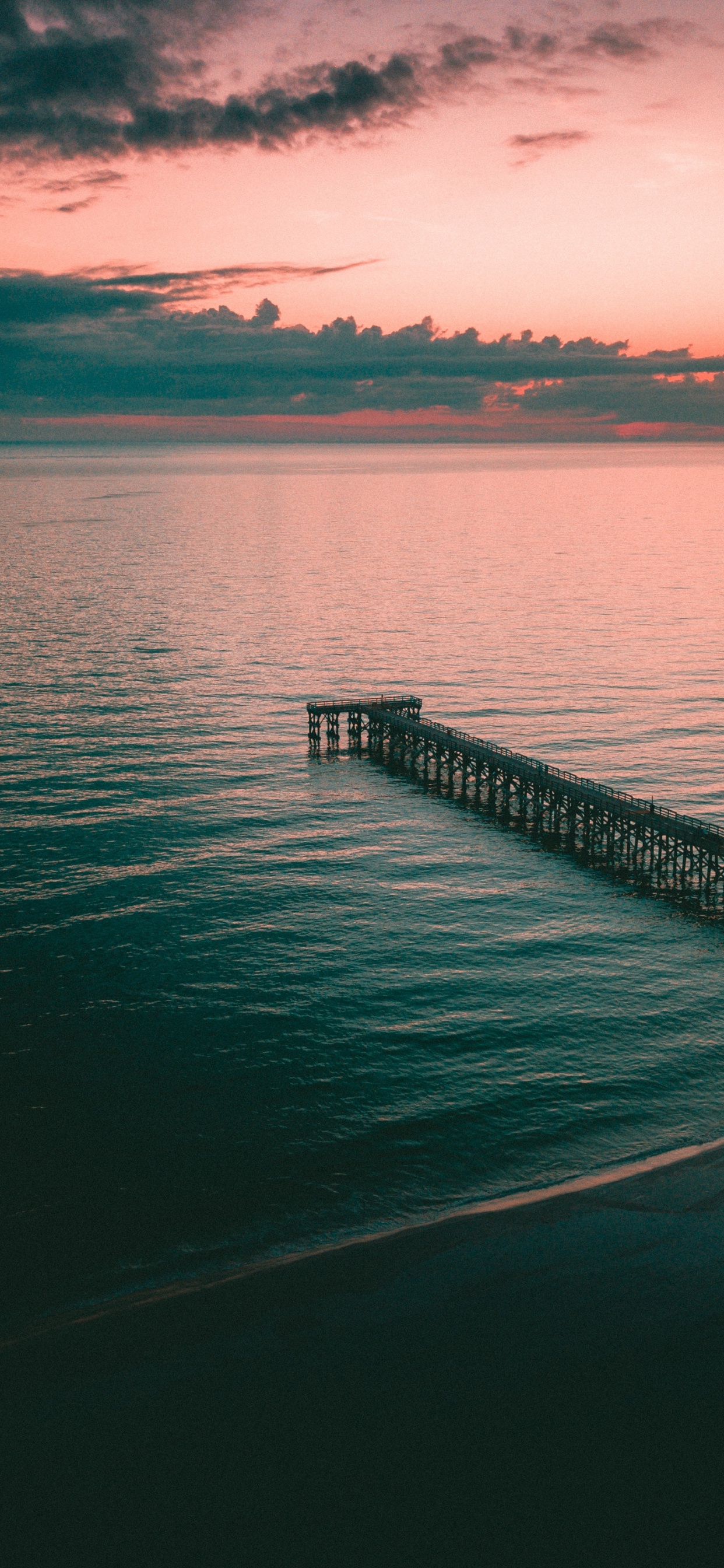 Brown Wooden Dock on Body of Water During Sunset. Wallpaper in 1242x2688 Resolution