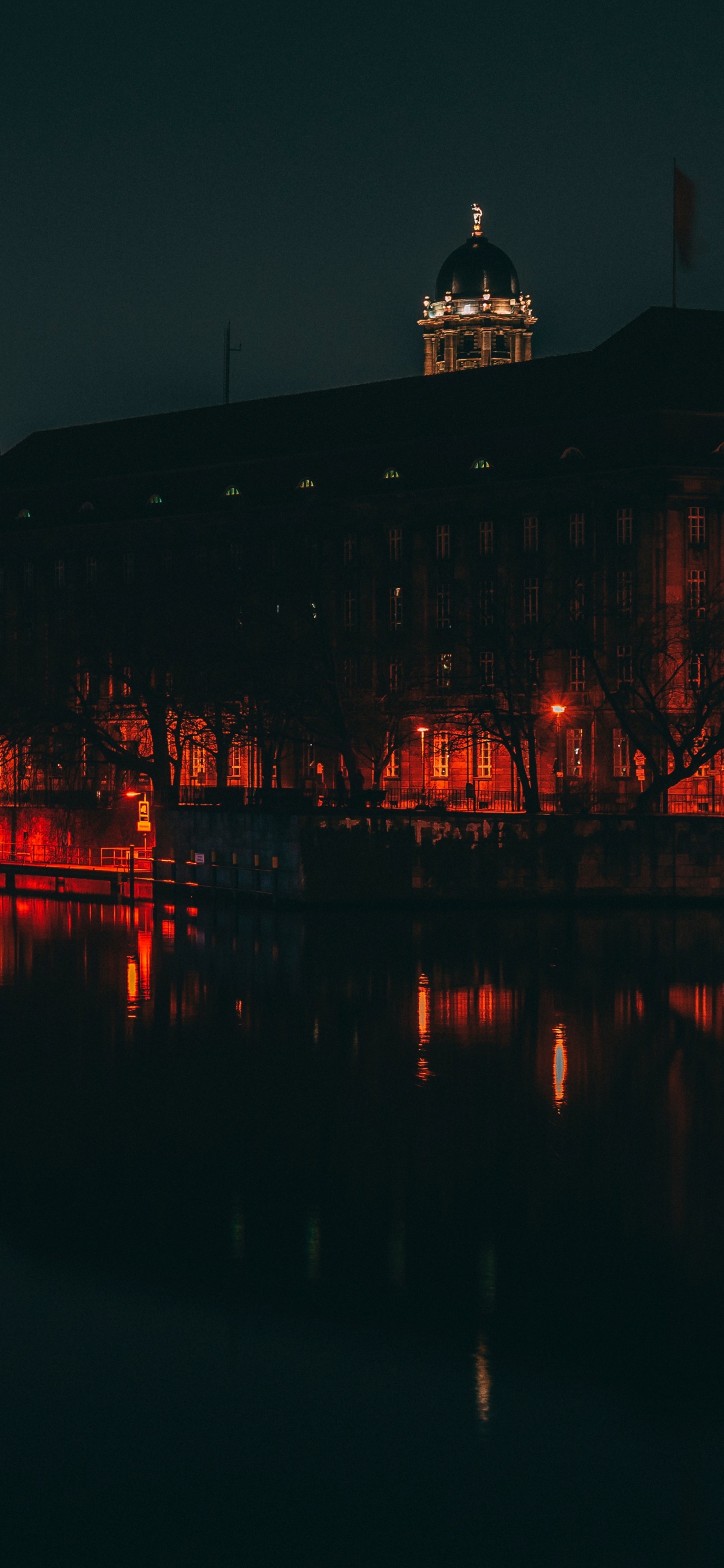 Body of Water Near City Buildings During Night Time. Wallpaper in 1242x2688 Resolution