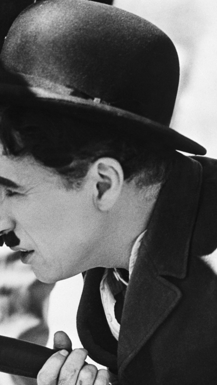 Mann Mit Schwarzem Hut Mit Kamera. Wallpaper in 720x1280 Resolution