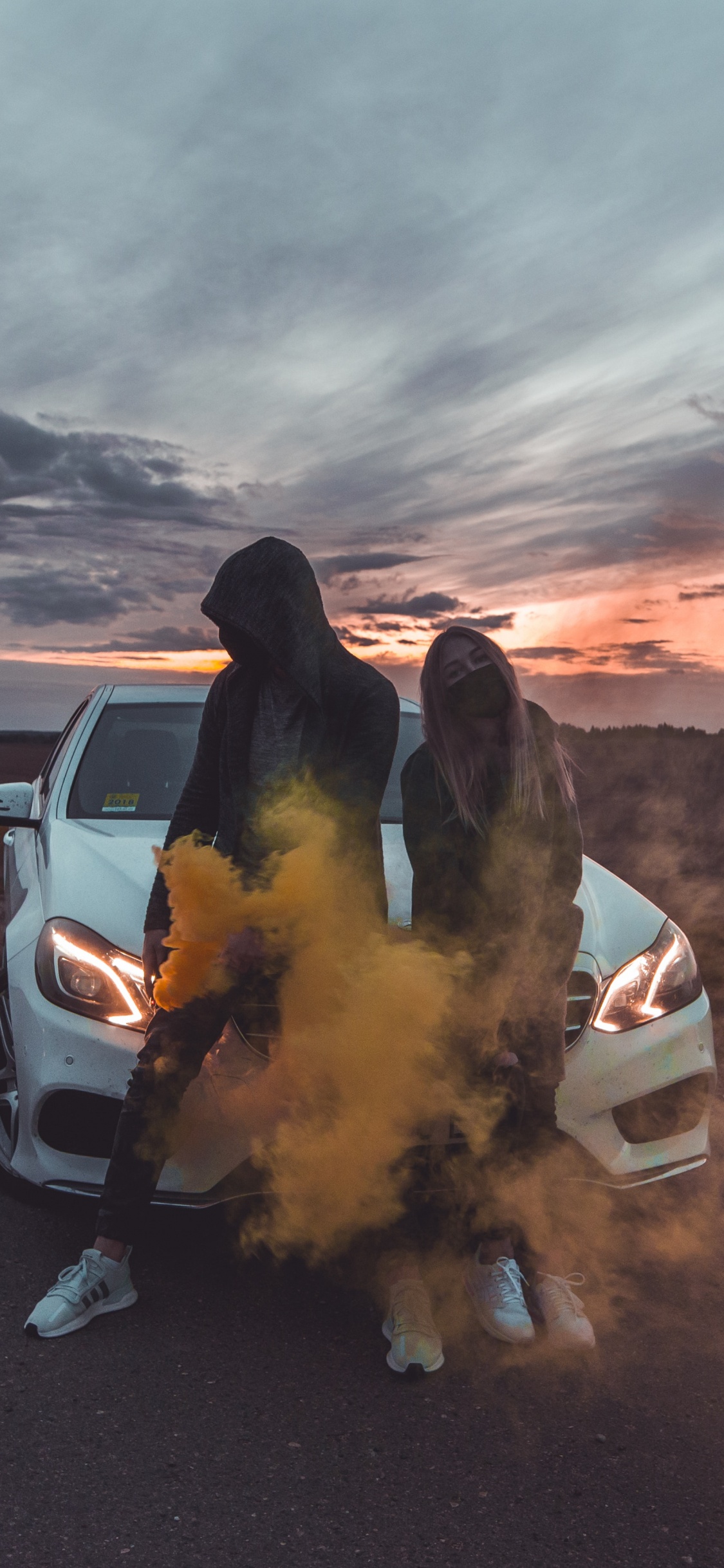 White Car on Gray Sand During Sunset. Wallpaper in 1125x2436 Resolution
