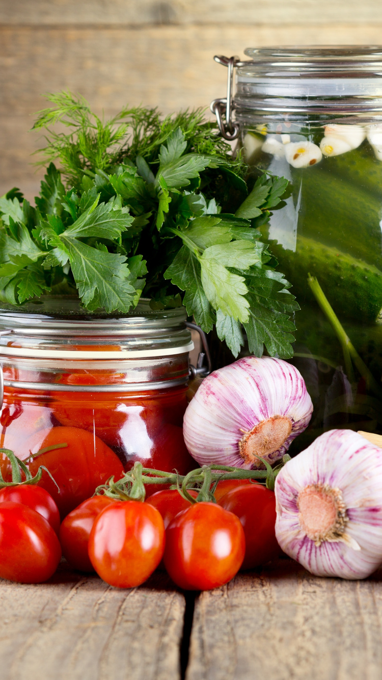Red Tomatoes and Green Leaves in Clear Glass Jar. Wallpaper in 750x1334 Resolution