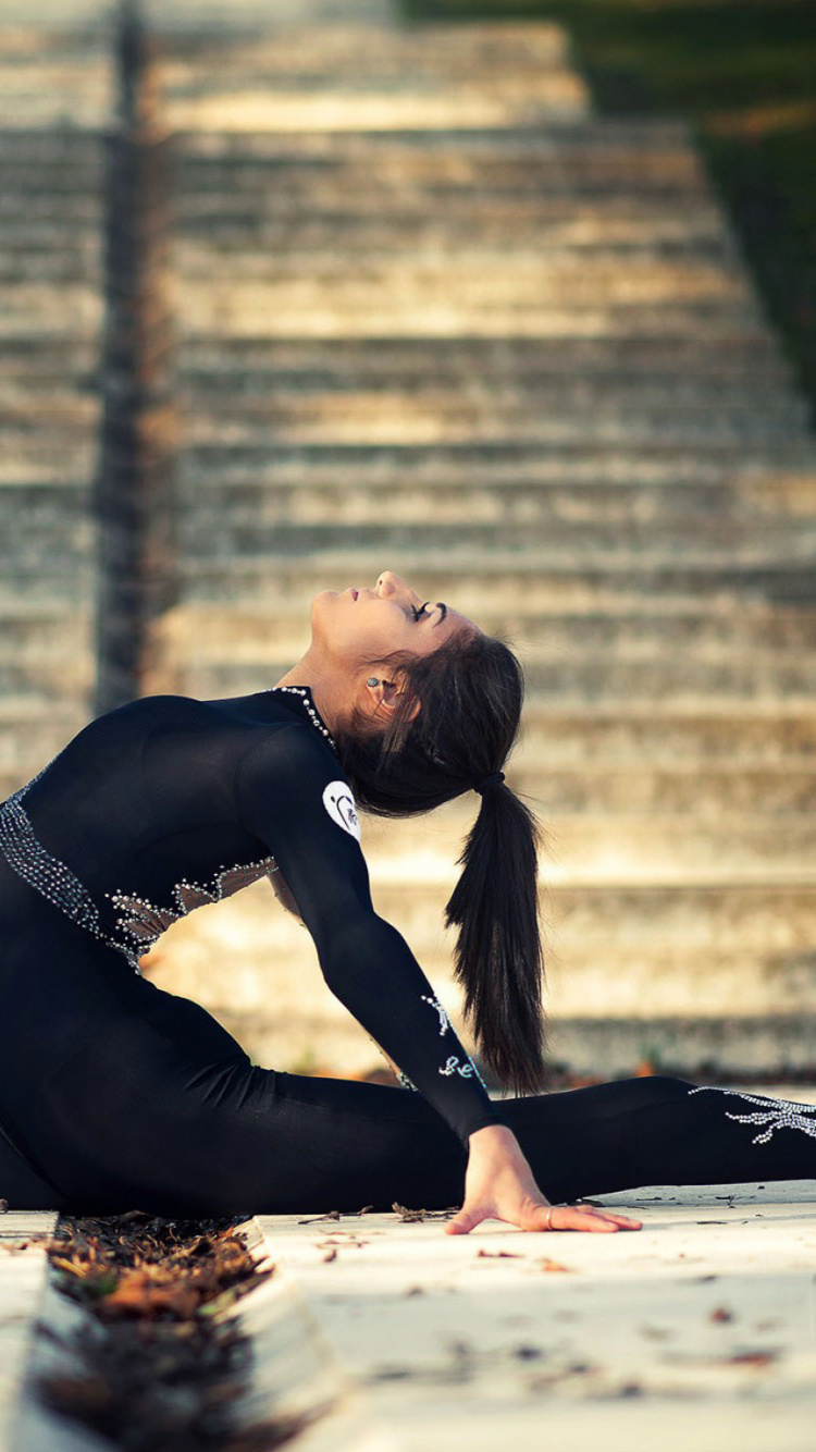 Woman in Black Long Sleeve Dress Lying on Ground During Daytime. Wallpaper in 750x1334 Resolution