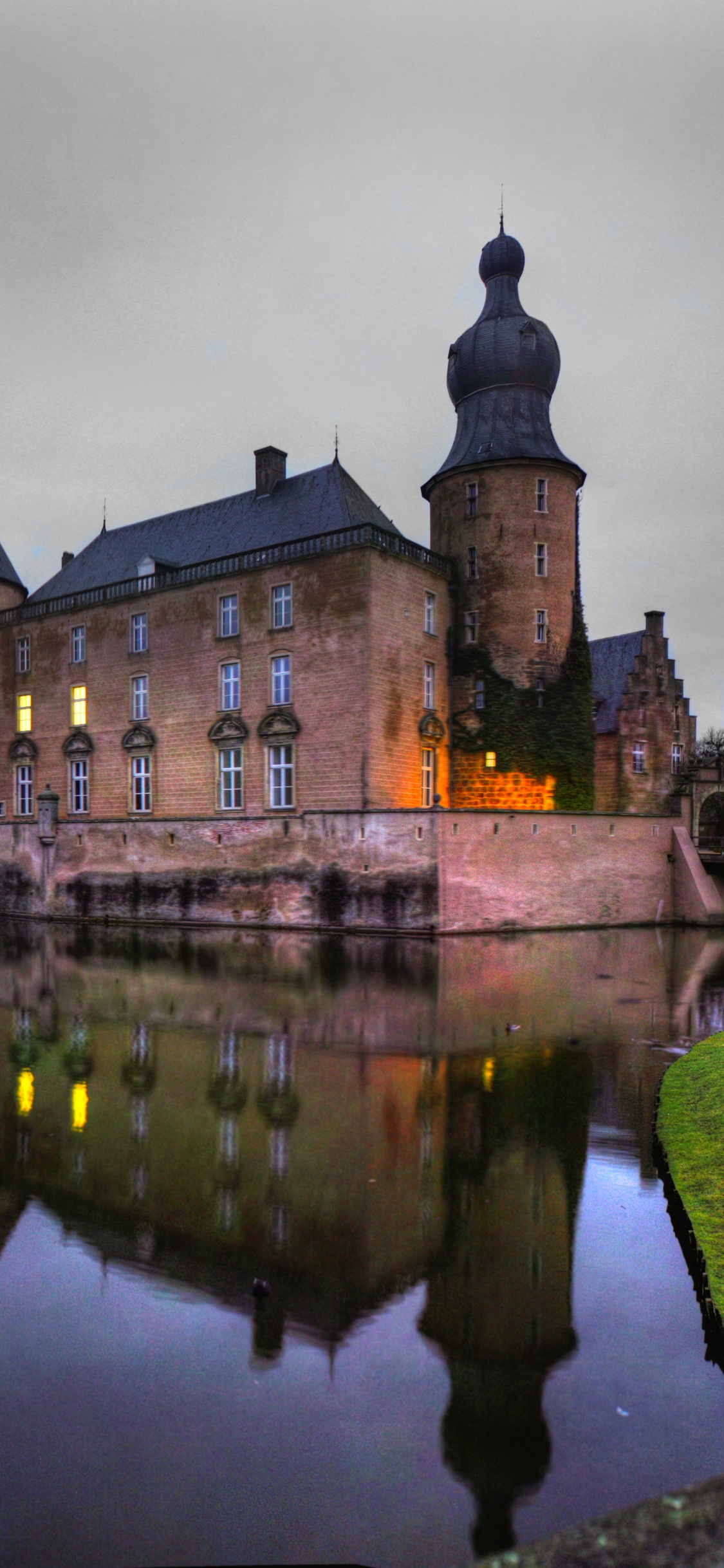 Braunes Betongebäude in Der Nähe Von Gewässern Unter Bewölktem Himmel Tagsüber. Wallpaper in 1125x2436 Resolution