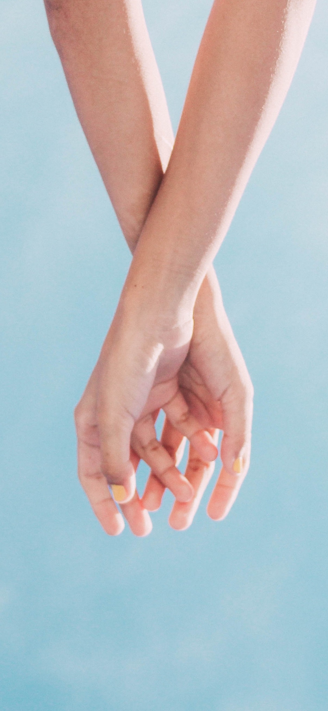 Persons Feet on Blue Surface. Wallpaper in 1125x2436 Resolution