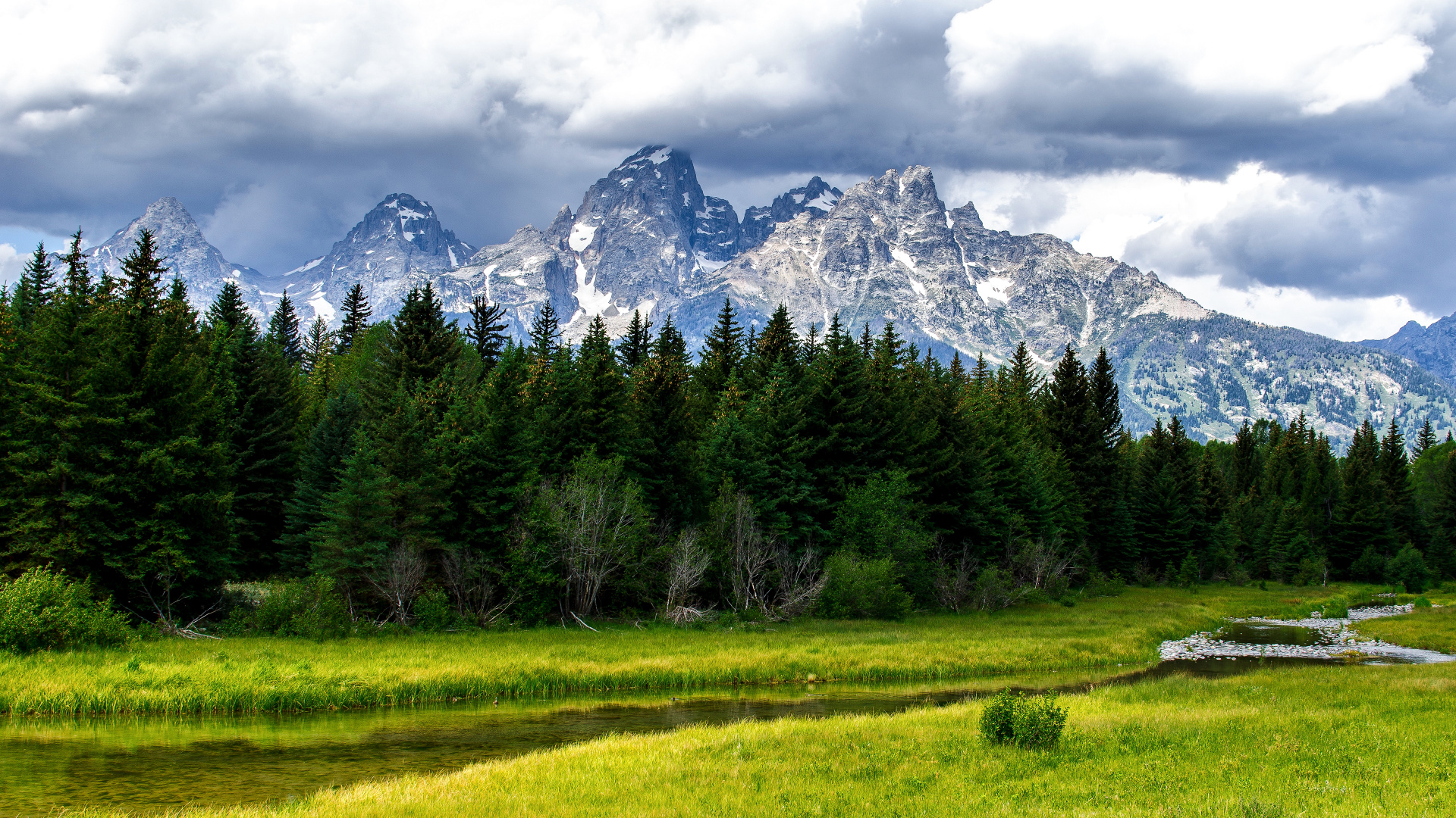 Green Grass Field Near Trees and Snow Covered Mountain During Daytime. Wallpaper in 1920x1080 Resolution