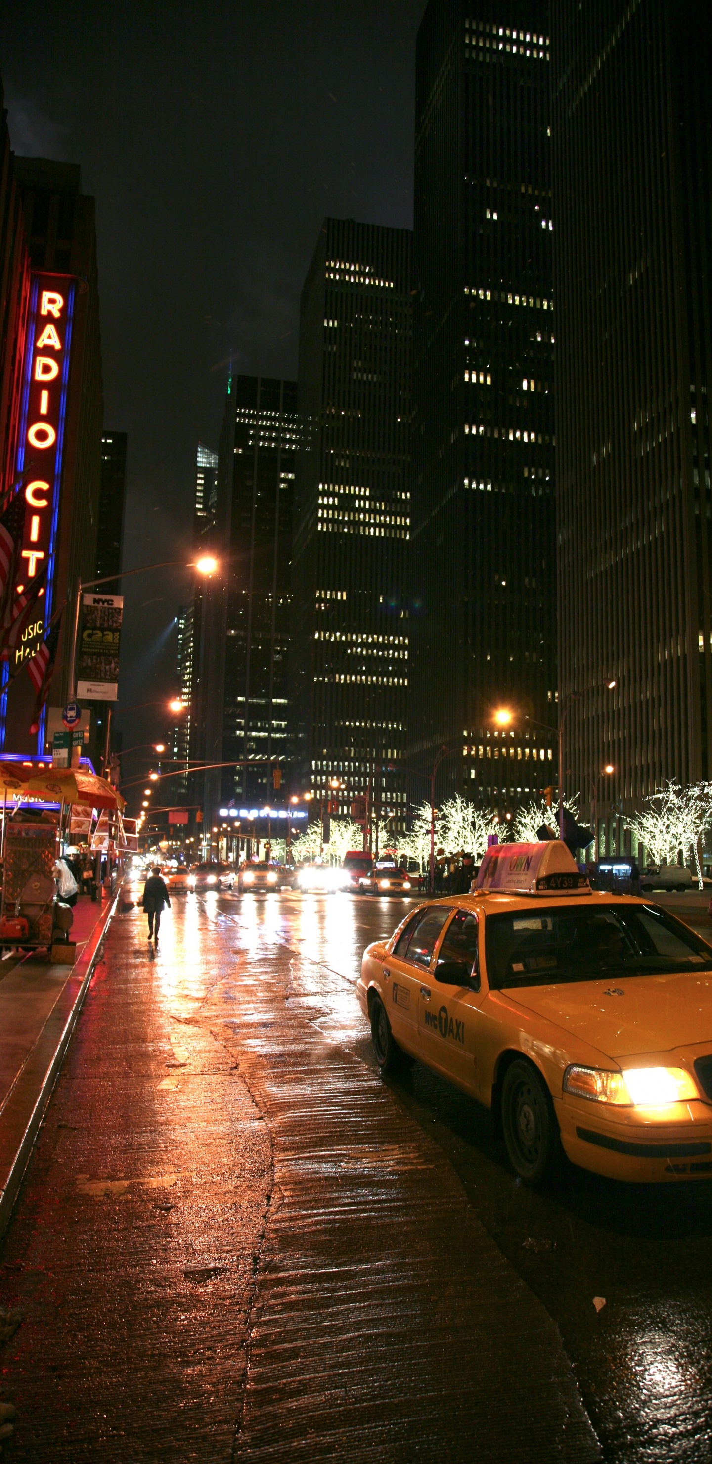 Cars on Road Near High Rise Buildings During Night Time. Wallpaper in 1440x2960 Resolution