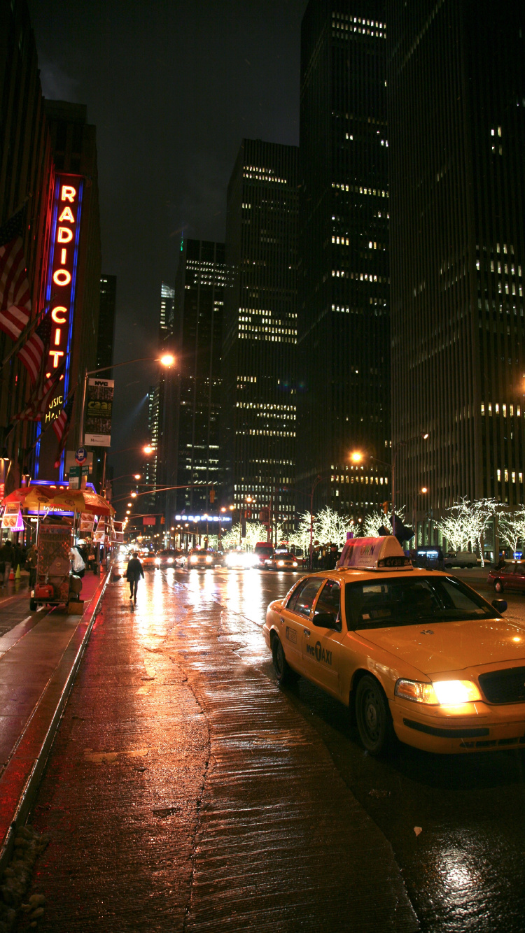 Cars on Road Near High Rise Buildings During Night Time. Wallpaper in 750x1334 Resolution