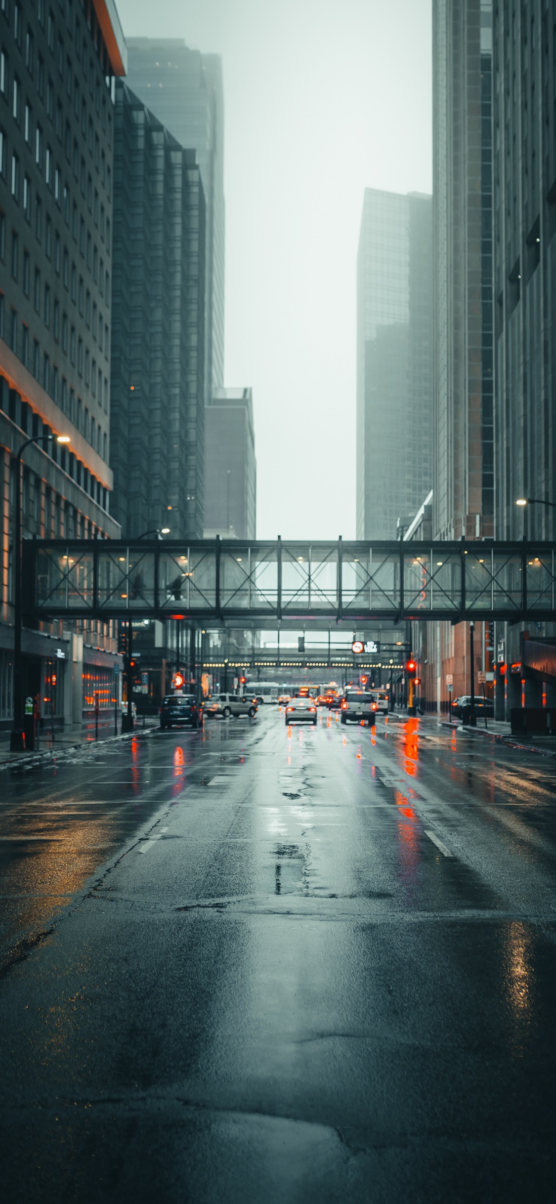 Cars on Road Between High Rise Buildings During Daytime. Wallpaper in 1125x2436 Resolution