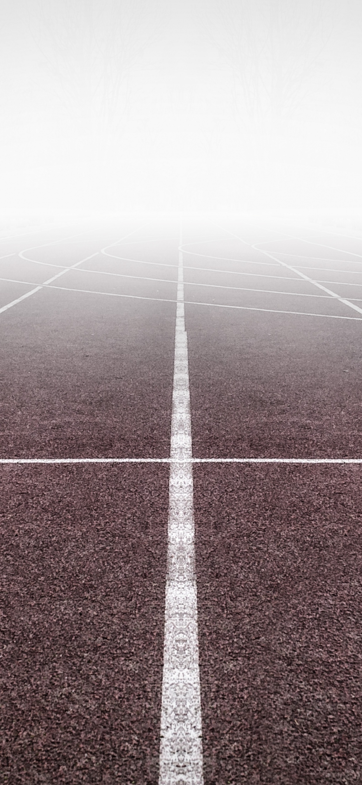White Arrow Sign on Green and White Track Field. Wallpaper in 1242x2688 Resolution