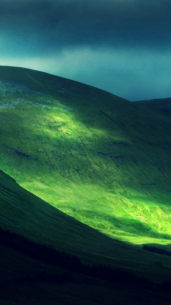 Green and Black Mountain Under Gray Clouds. Wallpaper in 720x1280 Resolution