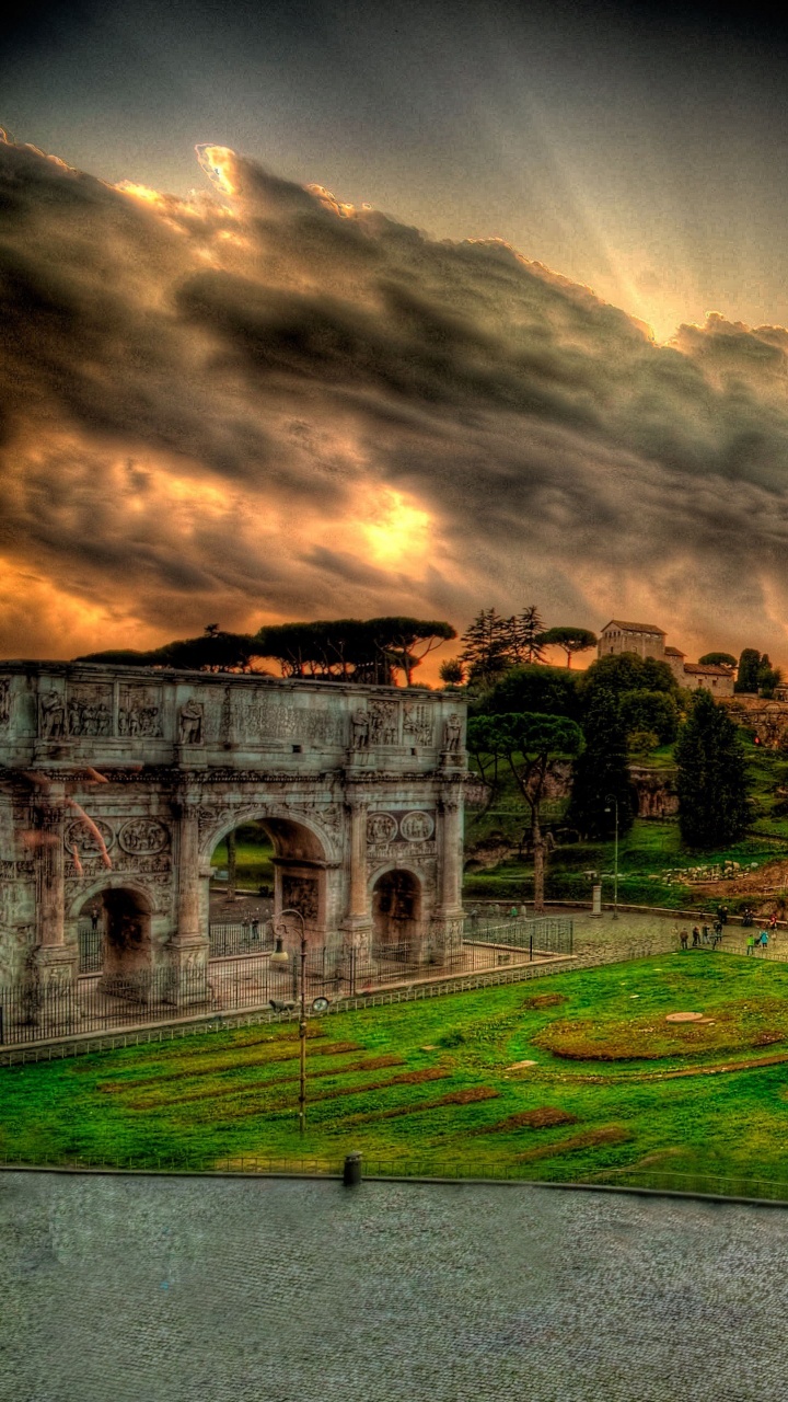 Green Grass Field Near Brown Building Under Cloudy Sky. Wallpaper in 720x1280 Resolution