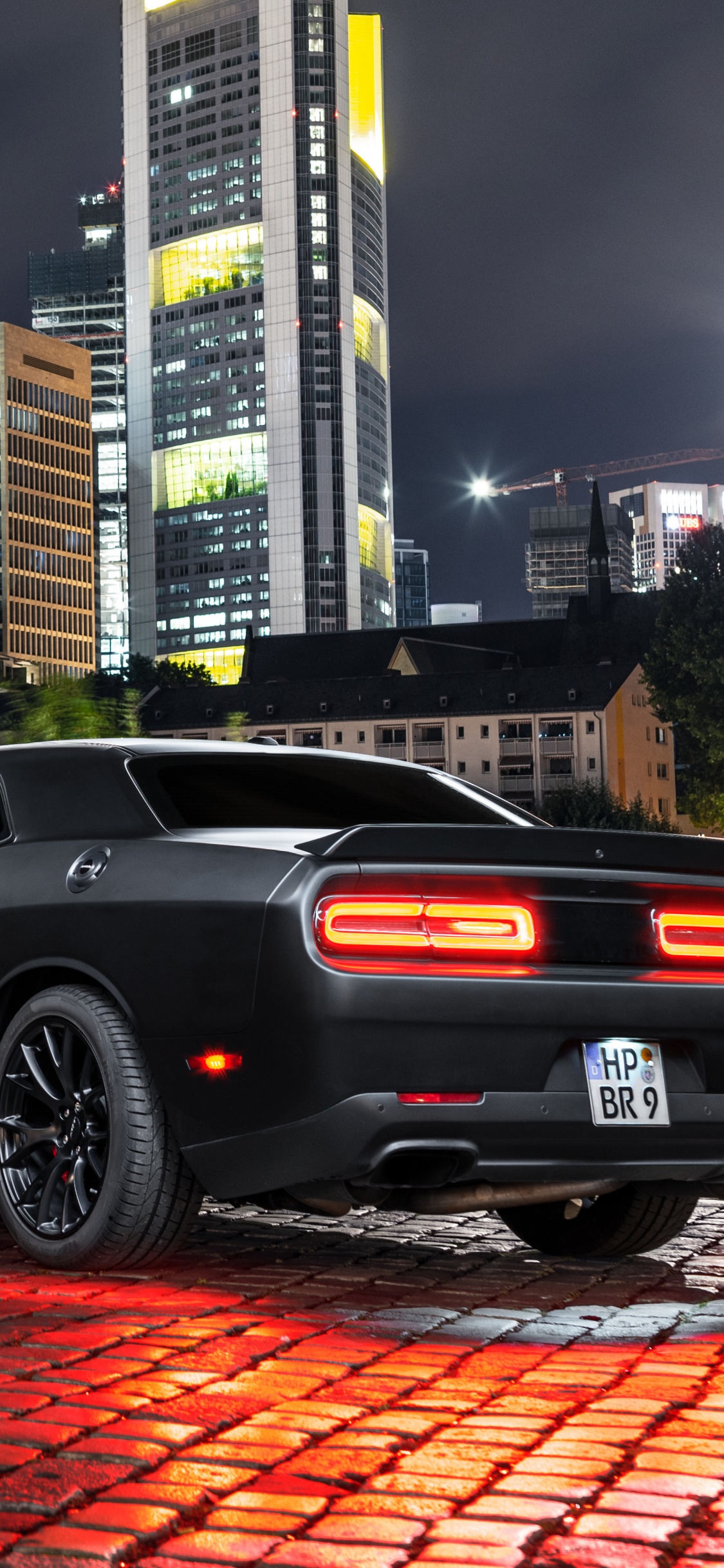 Black Coupe Parked Near Body of Water During Daytime. Wallpaper in 1125x2436 Resolution