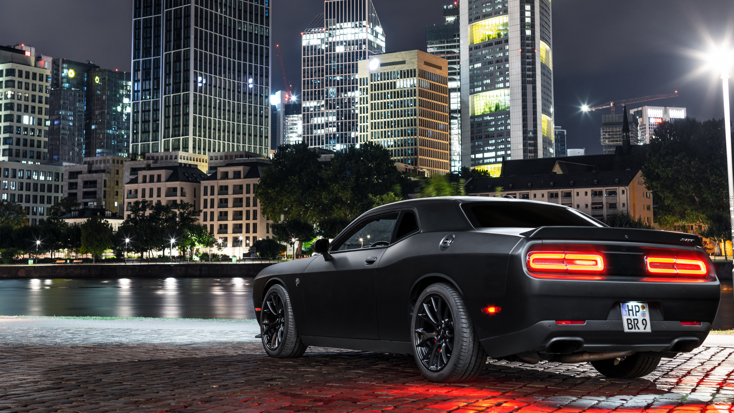 Black Coupe Parked Near Body of Water During Daytime. Wallpaper in 2560x1440 Resolution