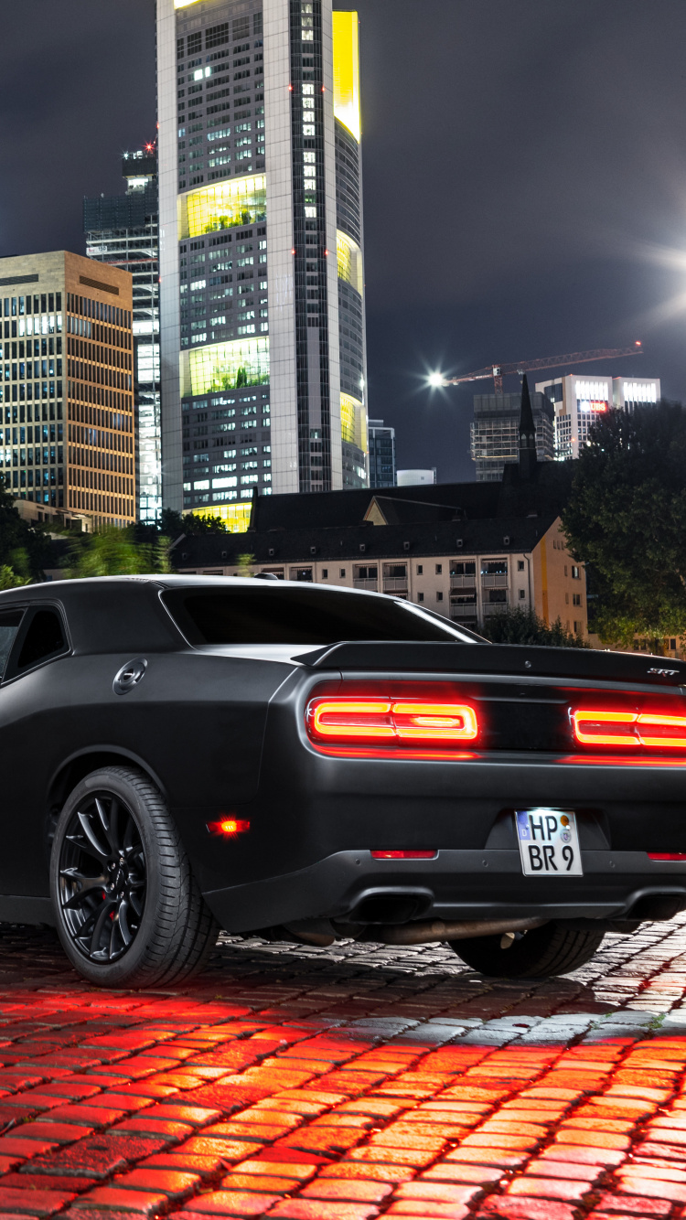 Black Coupe Parked Near Body of Water During Daytime. Wallpaper in 750x1334 Resolution