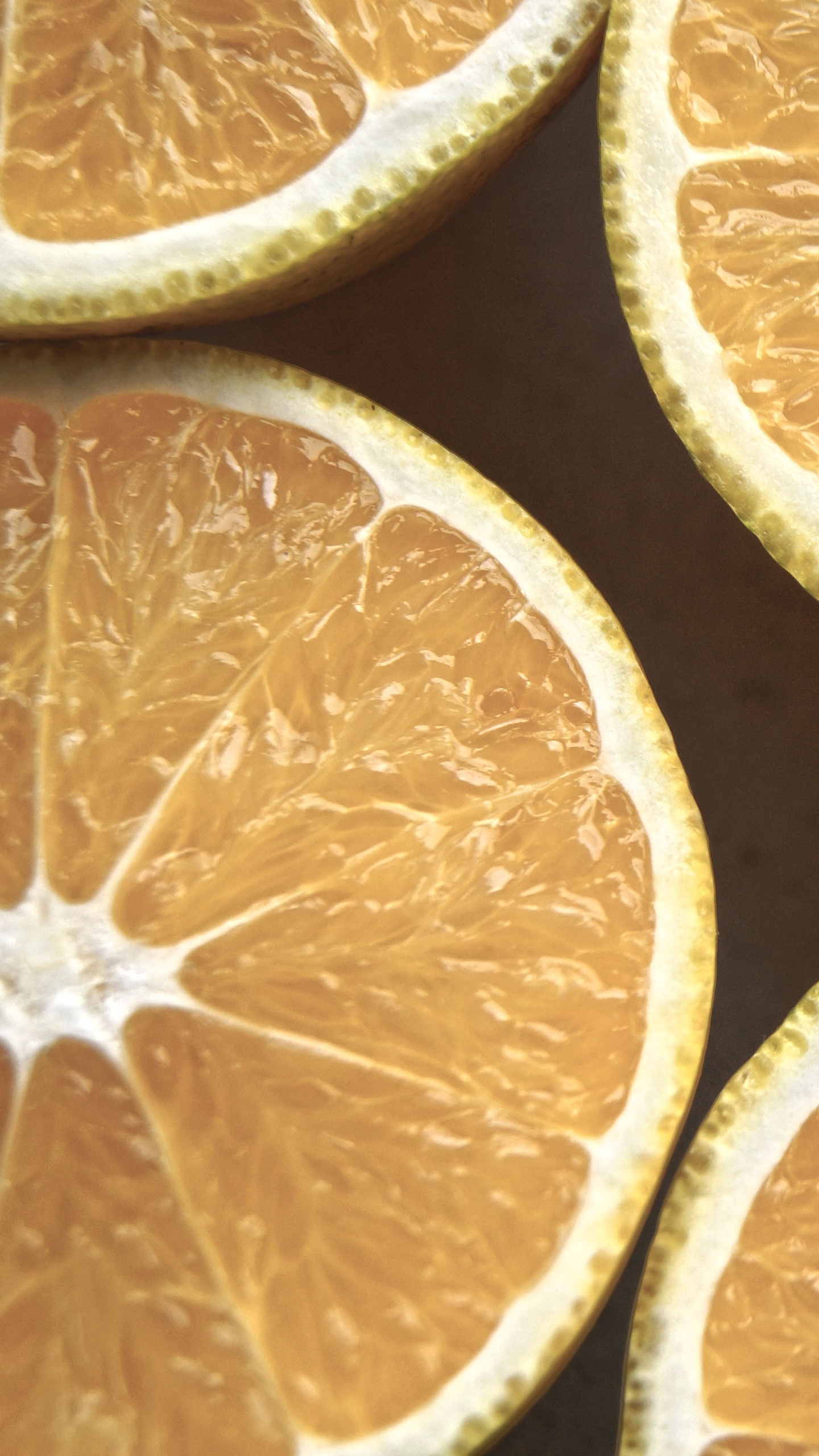 Sliced Orange Fruit on Black Surface. Wallpaper in 1440x2560 Resolution