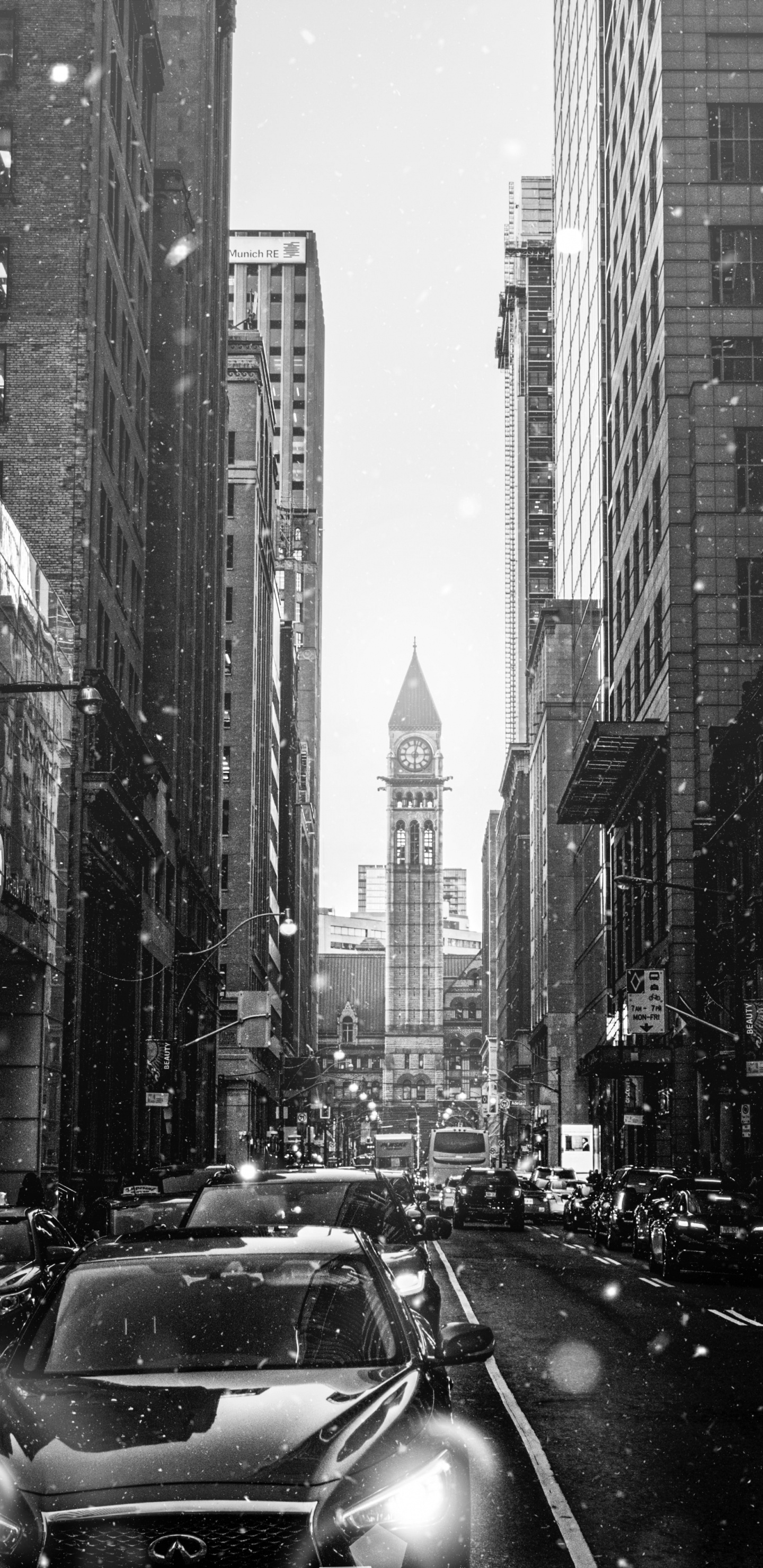 Grayscale Photo of Cars on Road Between High Rise Buildings. Wallpaper in 1440x2960 Resolution