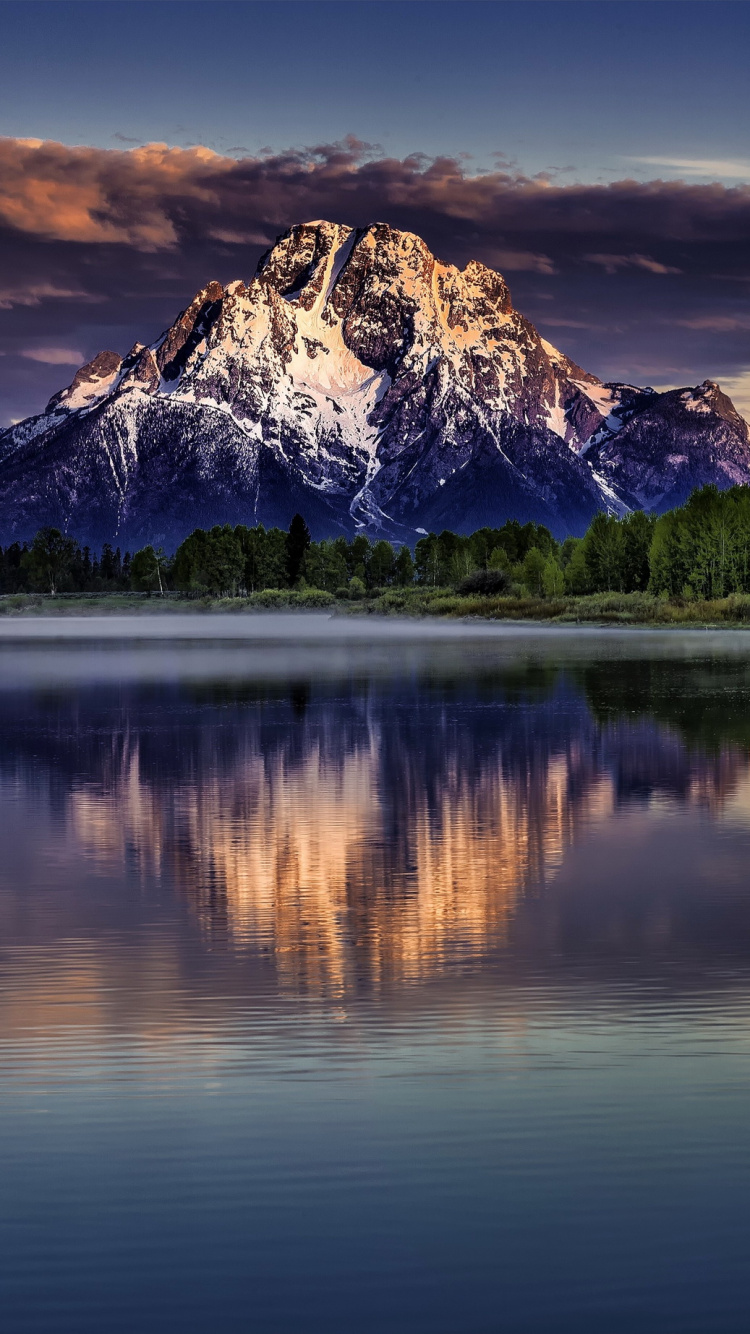Lake Near Mountain Under Blue Sky During Daytime. Wallpaper in 750x1334 Resolution
