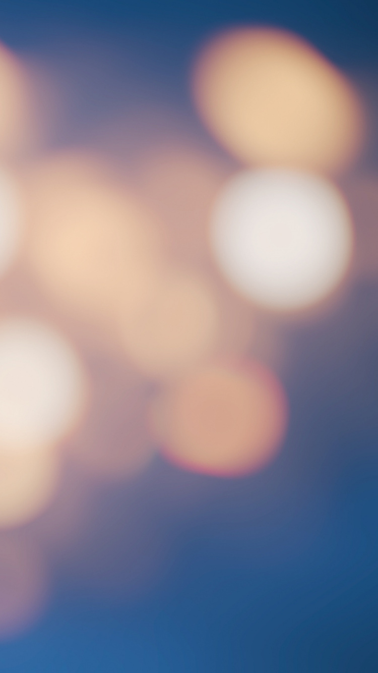 Gelbe Und Blaue Bokeh-Lichter. Wallpaper in 750x1334 Resolution