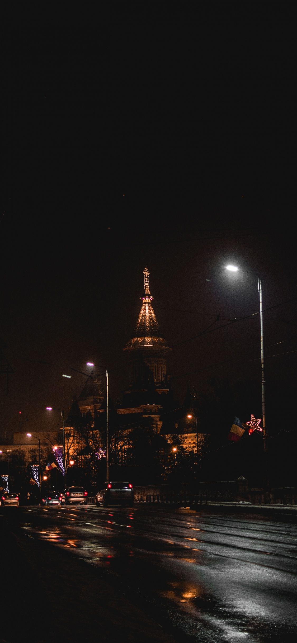 Cars on Road Near Building During Night Time. Wallpaper in 1125x2436 Resolution