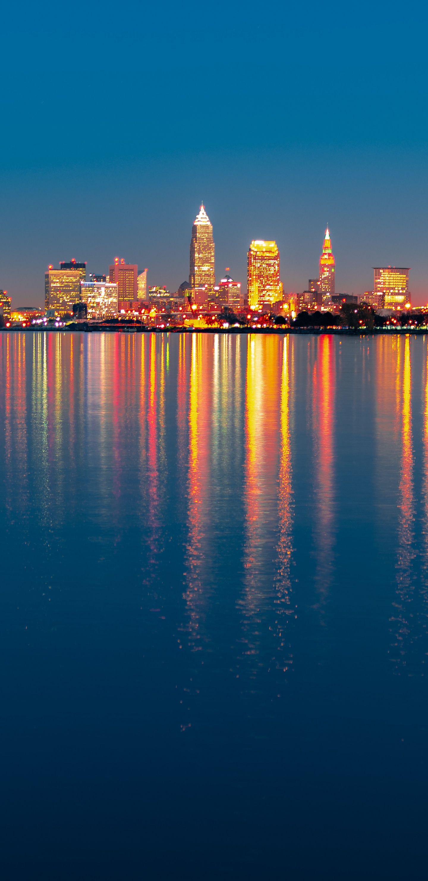 City Skyline Across Body of Water During Night Time. Wallpaper in 1440x2960 Resolution