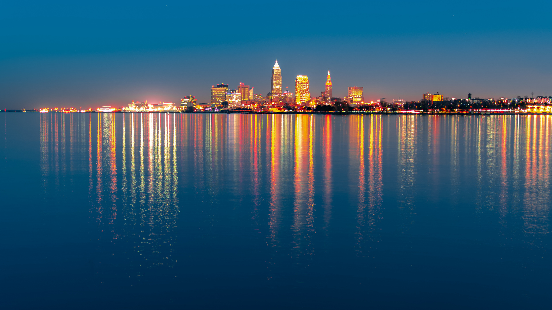 City Skyline Across Body of Water During Night Time. Wallpaper in 1920x1080 Resolution