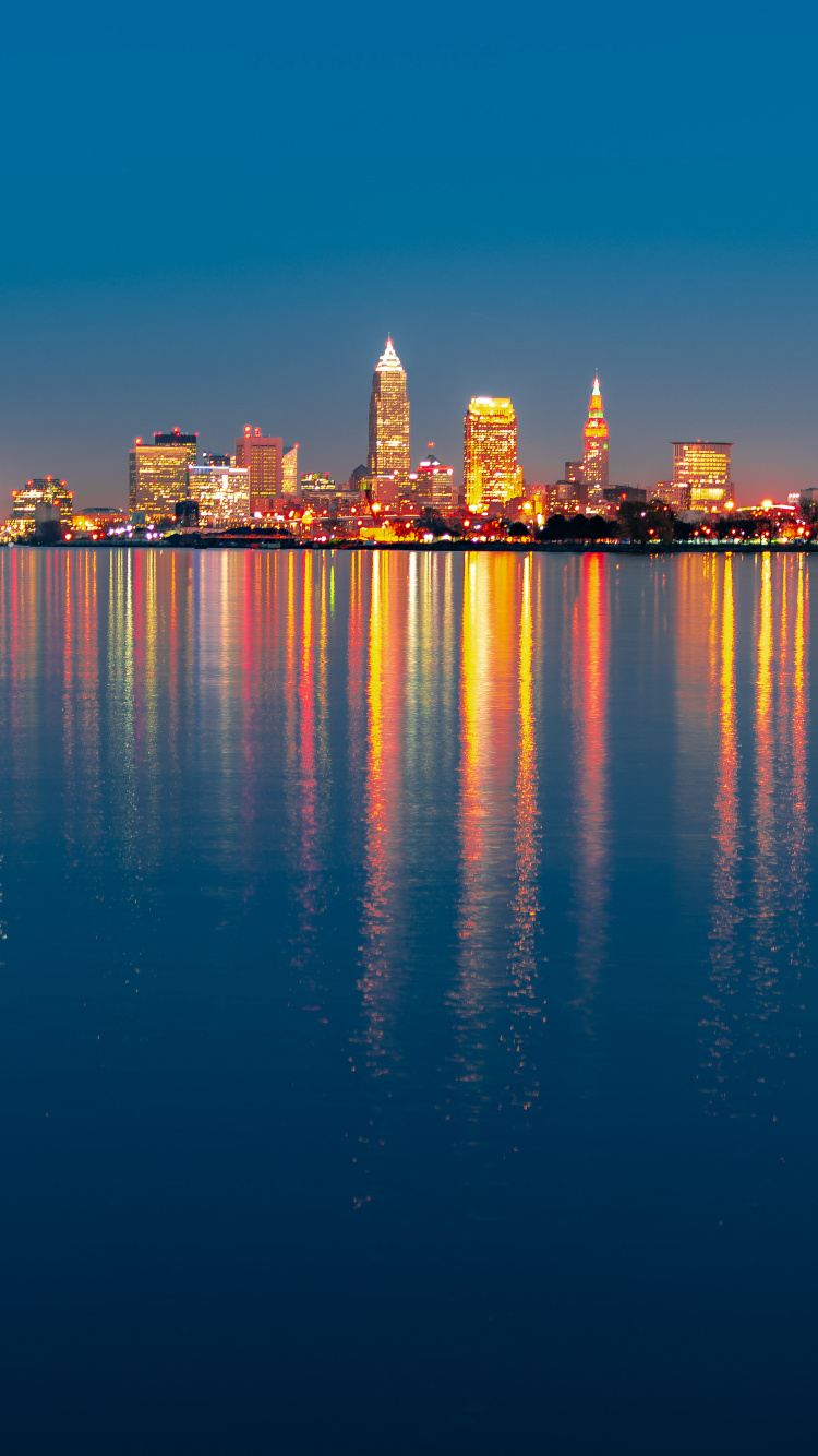 City Skyline Across Body of Water During Night Time. Wallpaper in 750x1334 Resolution