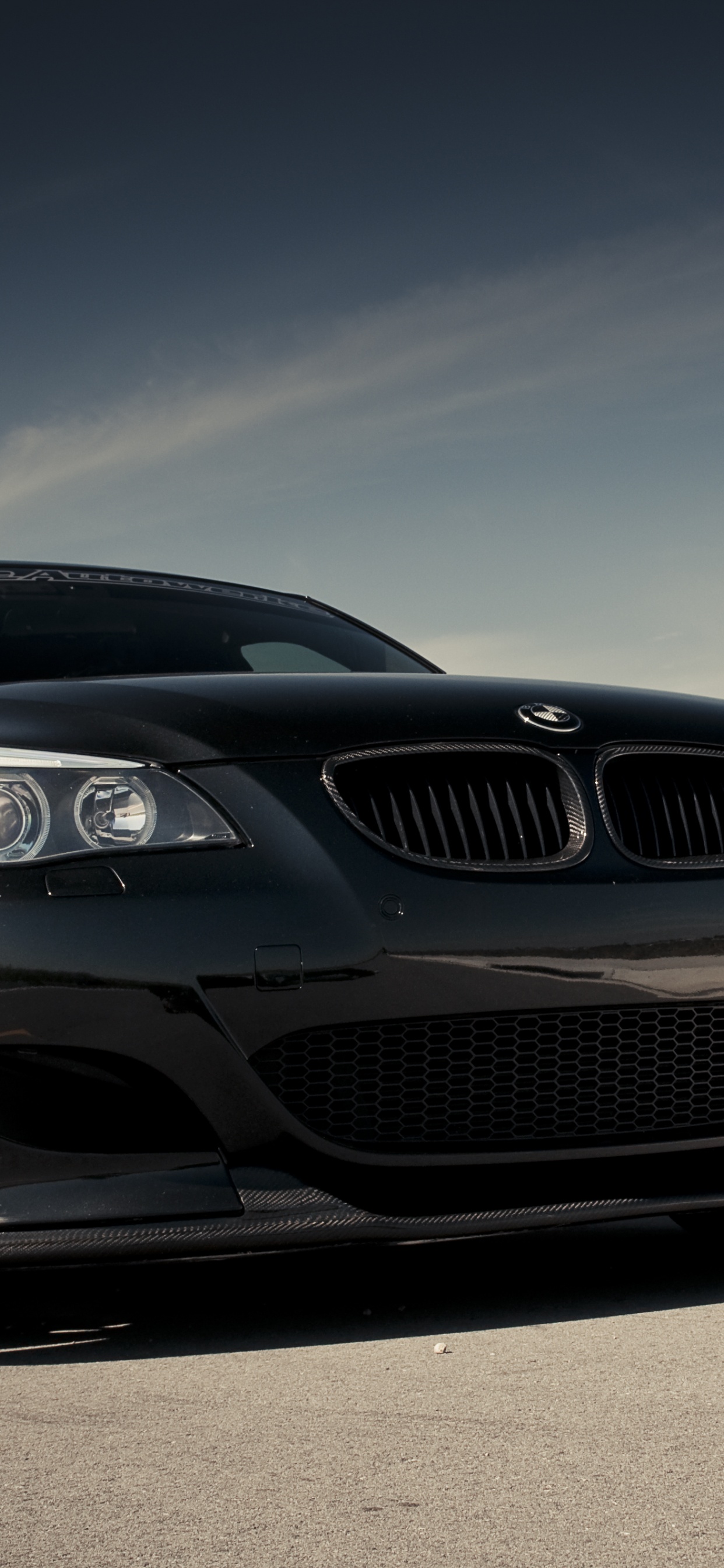 Schwarzes Bmw-auto Auf Grauer Asphaltstraße Tagsüber. Wallpaper in 1242x2688 Resolution